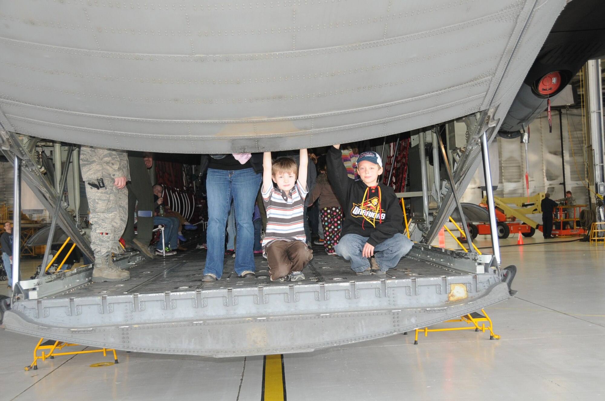 Parents and children from the Eagles Wings Home School coop tour a 934th Airlift Wing C-130 April 12. (Air Force Photo/Paul Zadach)
