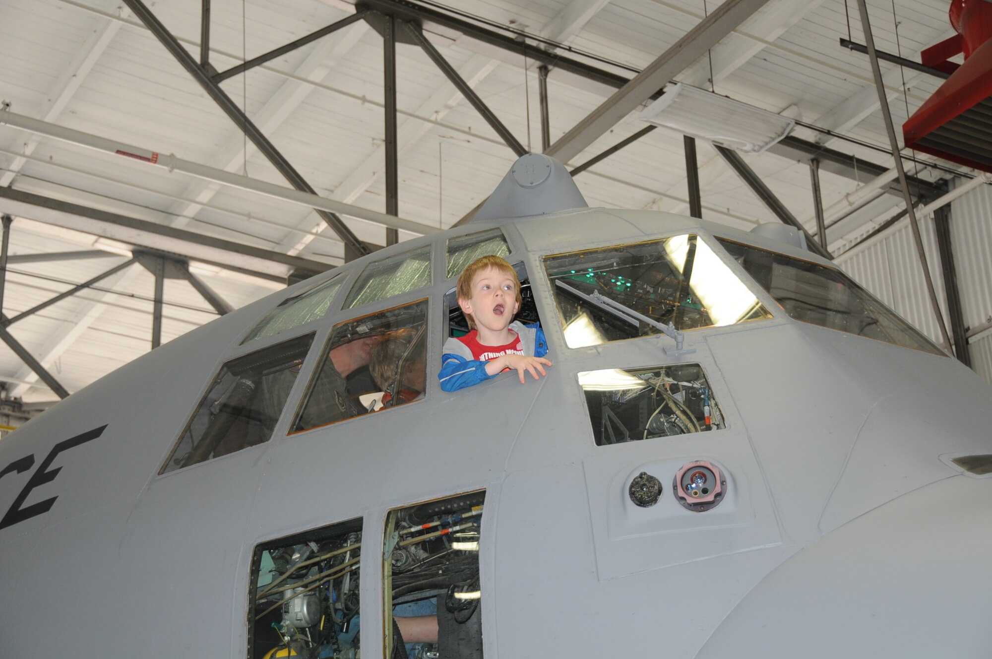 Parents and children from the Eagles Wings Home School coop tour a 934th Airlift Wing C-130 April 12. (Air Force Photo/Paul Zadach)