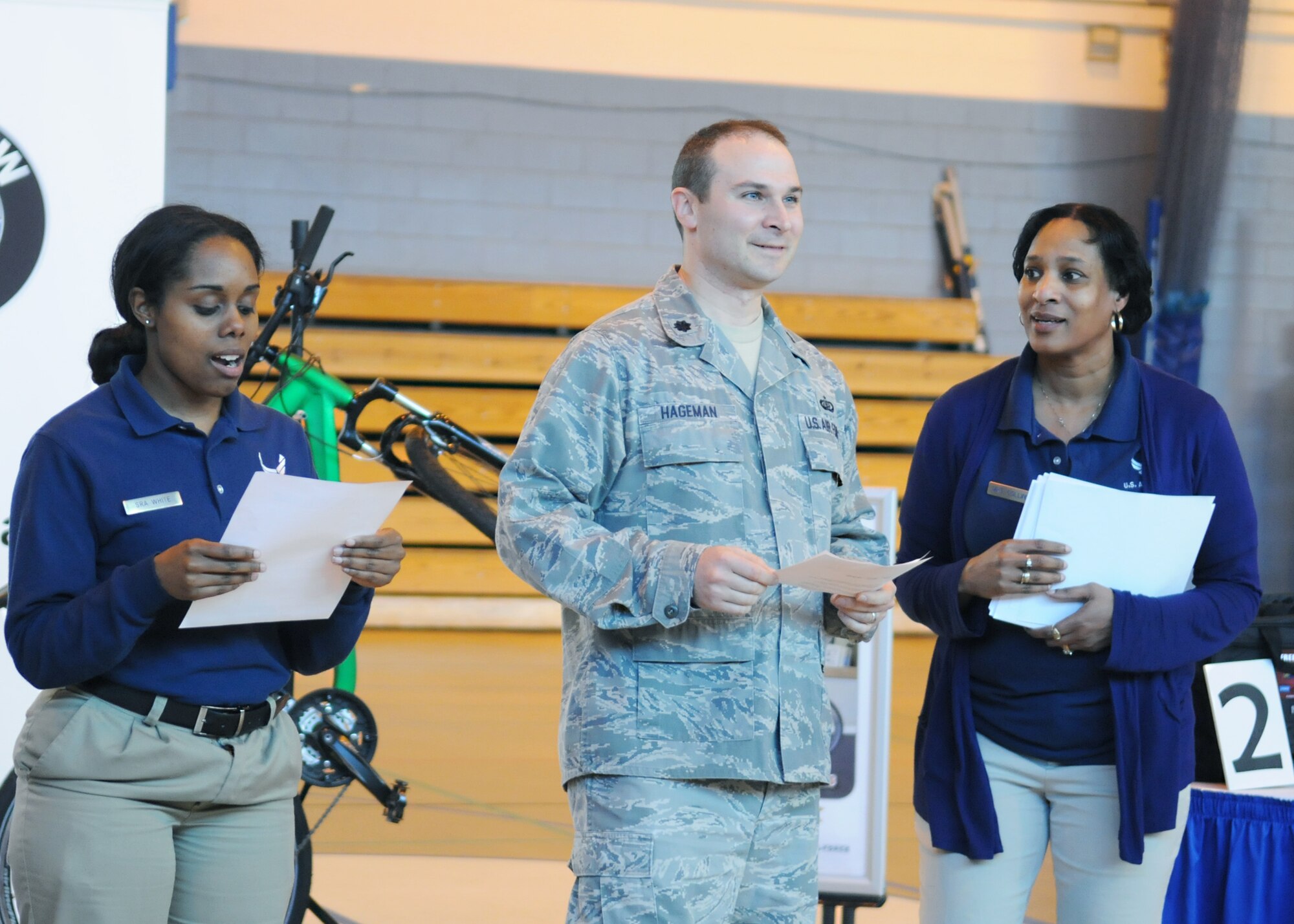 RAF MILDENHALL, England – Lt. Col. Adrian Hageman (center), 100th Force Support Squadron commander, and 100th Force Support Squadron fitness specialists, Senior Airman Santianna White (left) and Deborah Collins (right), acknowledge individuals who completed the RAF Mildenhall Biggest Loser Competition April 17, 2012, at the North Side Fitness Center.  In three months, 40 participants lost more than 500 pounds. (U.S. Air Force photo/Staff Sgt. Tabitha M. Lee)