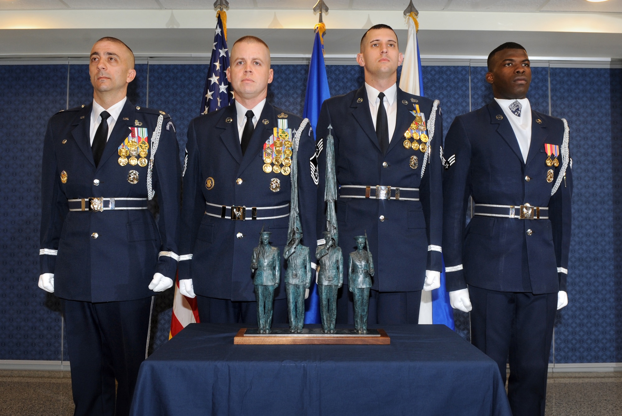 U.S. Air Force Honor Guard members from Joint Base Anacostia-Bolling, D.C., stand at attention during an April 13, 2012, Pentagon ceremony in which Air Force Association Chairman of the Board of Directors Sandy Schlitt presented the Air Force with a replica of the honor guard statue at the Air Force Memorial.  Air Force Chief of Staff Gen. Norton Schwartz accepted the statuette on behalf of the service.  The honor guard members are, from left, Lt. Col. Ken Marentette, Master Sgt. Matthew Lewis, Staff Sgt. Jesse Schierloh and Senior Airman Billy Degraffenreid.  (U.S. Air Force photo/Andy Morataya)