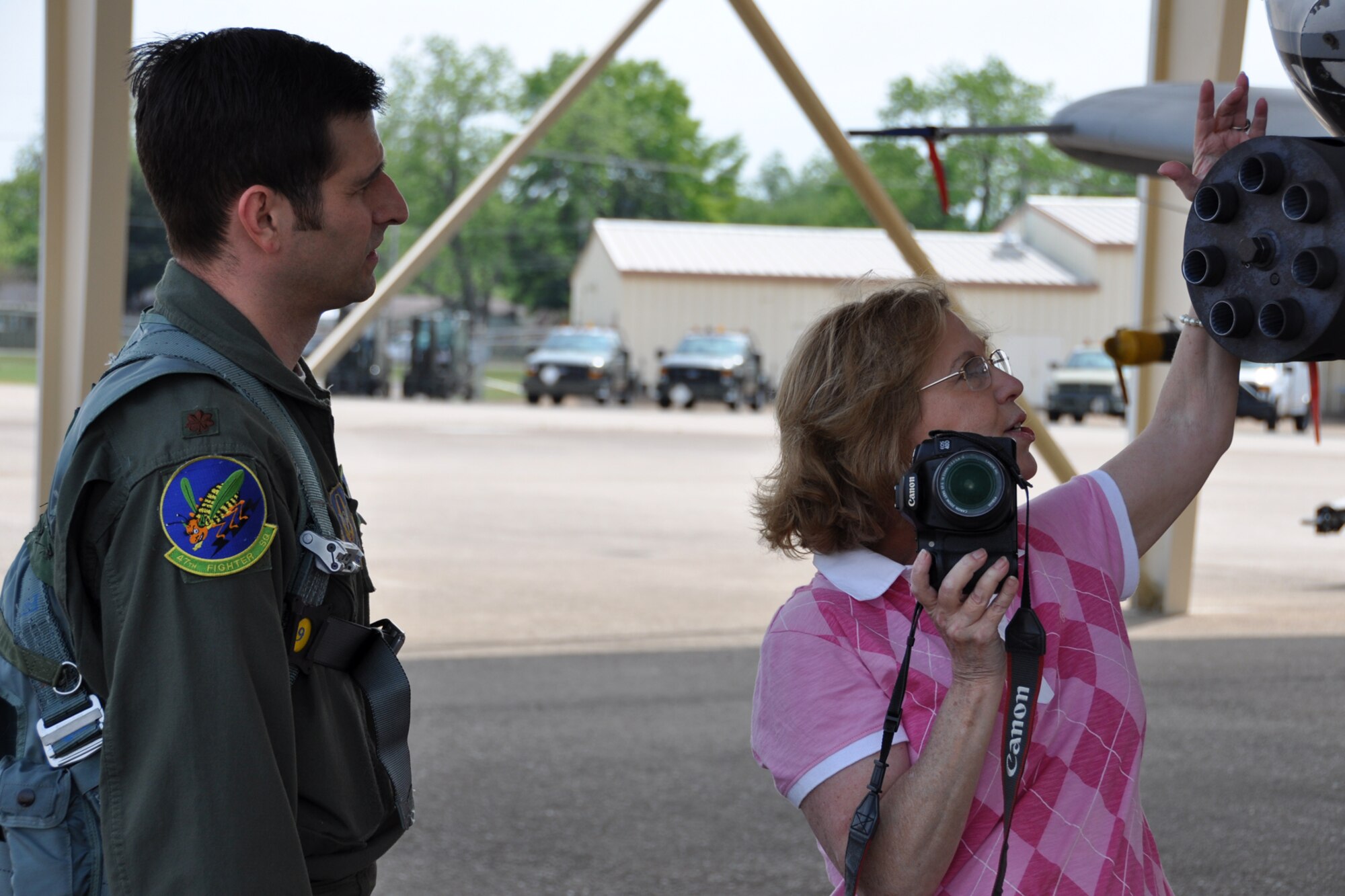 Lora Fairchild, a photographer for “The Forum” takes a photograph of Maj. Grant McCall for the cover of an issue of the newspaper at Barksdale Air Force Base, La., April 12, 2012. McCall is an A-10 pilot assigned to the 47th Fighter Squadron. “The Forum” is a free newspaper that brings bi-weekly information about the Shreveport/Bossier City area’s news, events, home, health and entertainment. (U.S. Air Force photo by Master Sgt. Jeff Walston)