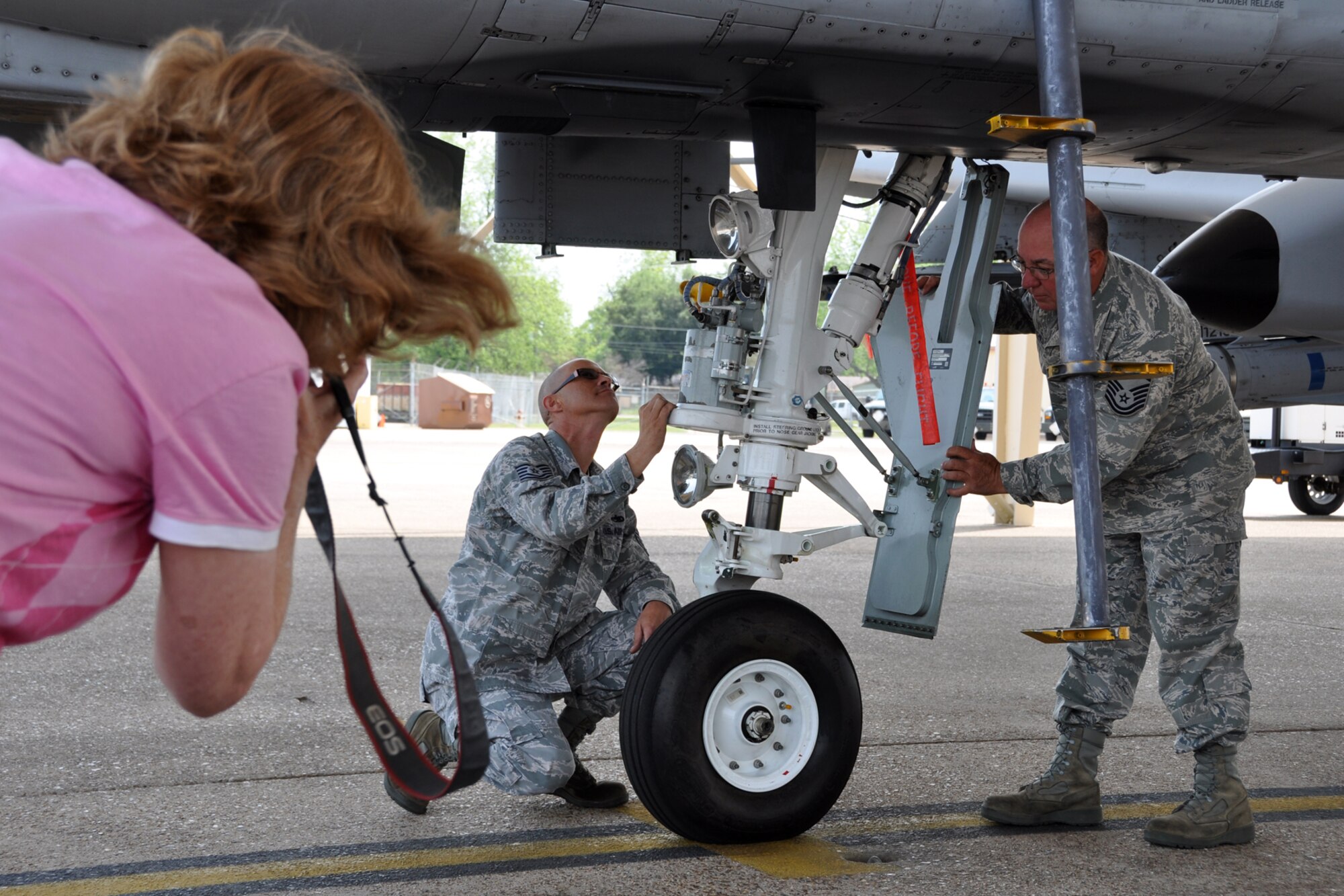 Lora Fairchild, a photographer for “The Forum” takes a photograph of Master Sgt. Edward Fairchild and Tech. Sgt. Christopher Duhe, for a story about hard-working Airmen at Barksdale Air Force Base, La, April 12, 2012. Sergeants Fairchild and Duhe are crew chiefs for the A-10 Thunderbolt II.  “The Forum” is a free newspaper that brings bi-weekly information about the Shreveport/Bossier City area’s news, events, home, health and entertainment. (U.S. Air Force photo by Master Sgt. Jeff Walston)