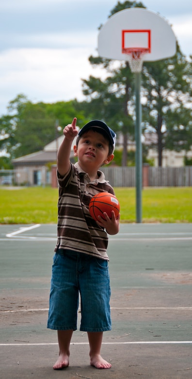 Three-year-old Hunter, son of Tricia and Staff Sgt. Justin Hoffman, 15th Airlift Squadron loadmaster, 437th Airlift Wing, plays basketball at a Joint Base Charleston –Air Base park April 14. Hunter is very coordinated for his age group and enjoys watching and playing hockey. Hunter was recently diagnosed with moderate to severe classical autism. He attends Applied Behavior Analysis therapy at school to counteract the symptoms of the disease. (U.S. Air Force photo by Airman 1st Class Dennis Sloan)