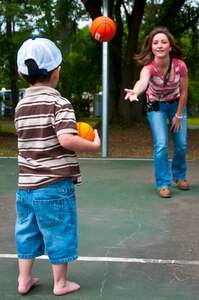 Tricia Hoffman, wife of Staff Sgt. Justin Hoffman, 15th Airlift Squadron loadmaster, 437th Airlift Wing, throws a ball to her three-year-old son Hunter at a Joint Base Charleston – Air Base park April 14. Hunter was recently diagnosed with moderate to severe classical autism. He struggles with speaking, understanding directions and transitioning from one task to the next. Hunter may struggle with simple tasks due to his autism, but he is very coordinated for his age and is able to retain large amounts of information. (U.S. Air Force photo by Airman 1st Class Dennis Sloan)