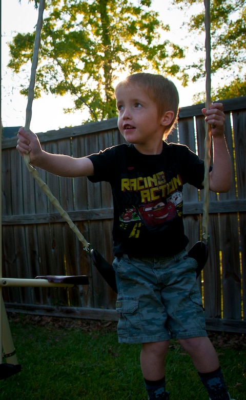 Six-year-old Carl, son of Sarah and Tech. Sgt. Carl Sole, 628th Security Forces Squadron flight chief, sits in a swing in his backyard during a break from his Applied Behavior Analysis therapy April 13. Carl was diagnosed with Autism Spectrum Disorder in addition to epilepsy, cerebral palsy and intellectual disabilities as a result of periventricular leukomalacia. Because Carl has cerebral palsy, he has to exercise often to keep his muscles loose and strong. (U.S. Air Force photo by Airman 1st Class Dennis Sloan)