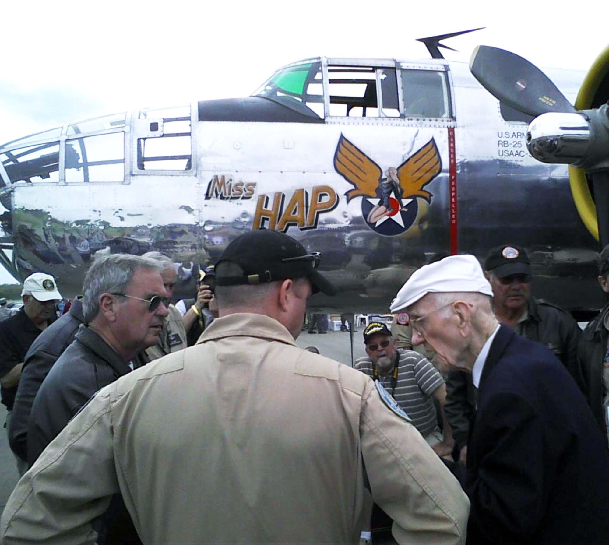 Maj. Thomas C. Griffin (right), one of five surviving members of the famous Doolittle Raiders, chats with crew members of the Miss Hap B-25 bomber at the National Museum of the United States Air Force April 17, 2012. Griffin and other Raiders are at the museum this week for the 70th anniversary of the famous Doolittle Raid. On April 18, 1942, 80 airmen took off in B-25 bombers from the aircraft carrier Hornet on a top-secret mission to bomb Japan. Some 20 B-25s gathered at the museum and will take part in a memorial flyover April 18. (U.S. Air Force photo/Ron Fry)