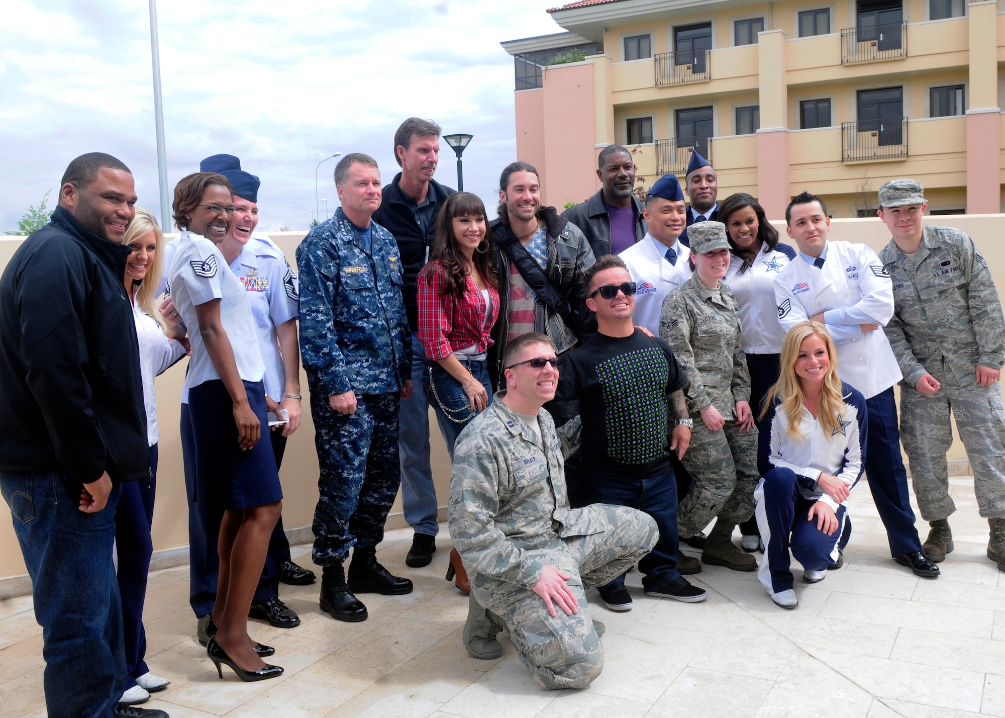 Members of the United Services Organization pose with Airmen of the La Dolce Vita Dining Facility April 16 at Aviano Air Base, Italy. Members of the USO tour dined with selected Airmen, answered questions, signed autographs, and took photos after the meal. (U.S. Air Force photo/Airman 1st Class Briana Jones)