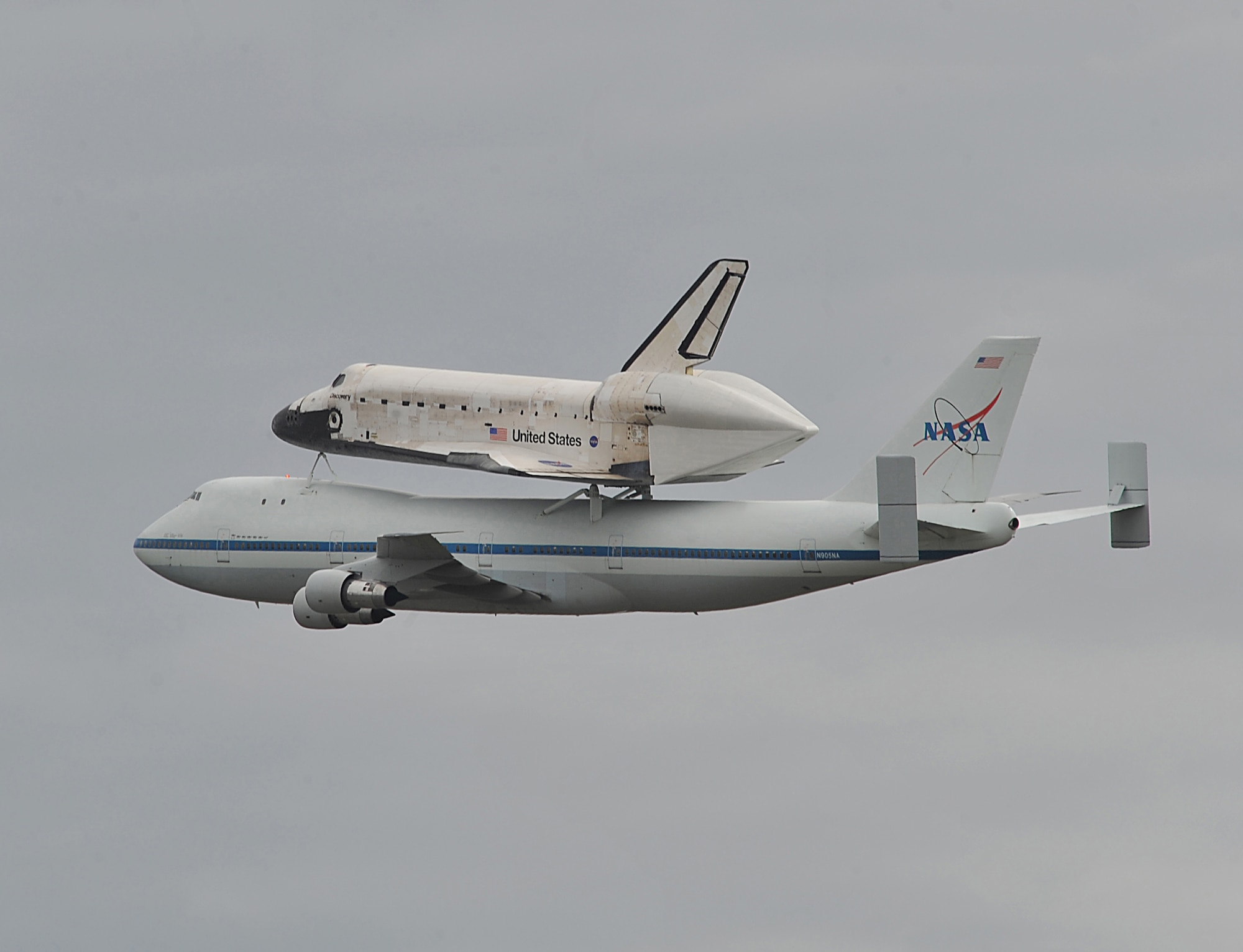 The space shuttle Discovery, sitting on top of a modified NASA Boeing 747 aircraft, flies over Washington Dulles International Airport in Dulles, Va., April 17, 2012. The Discovery made its final voyage to the Smithsonian National Air and Space Museum annex in Virginia. (U.S. Air Force photo by Val Gempis)