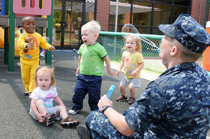 Petty Officer 3rd Class Steven Swan blows bubbles for toddlers during playtime at the Child Development Center at Joint Base Charleston – Weapons Station April, 11. Swan, a Machinist’s Mate from Rockmart, Ga., works at the CDC while waiting on his next set of orders. (U.S. Navy photo/Petty Officer 1st Class Jennifer Hudson)