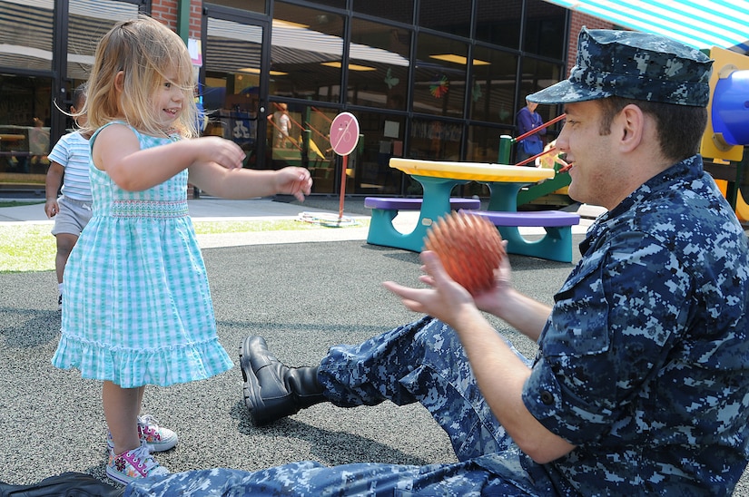 Petty Officer 3rd Class Brandon Bolte tosses a ball with two-year-old Brooke Holcomb during playtime at the Child Development Center at Joint Base Charleston – Weapons Station April, 11. Bolte, an Electrician’s Mate from Fort Collins, Colo., is working at the CDC while waiting for his next set of orders. Brooke is the daughter of Jonathan and Jaqueline Holcomb who work at Space and Naval Warfare Systems Command Atlantic. (U.S. Navy photo/Petty Officer 1st Class Jennifer Hudson)