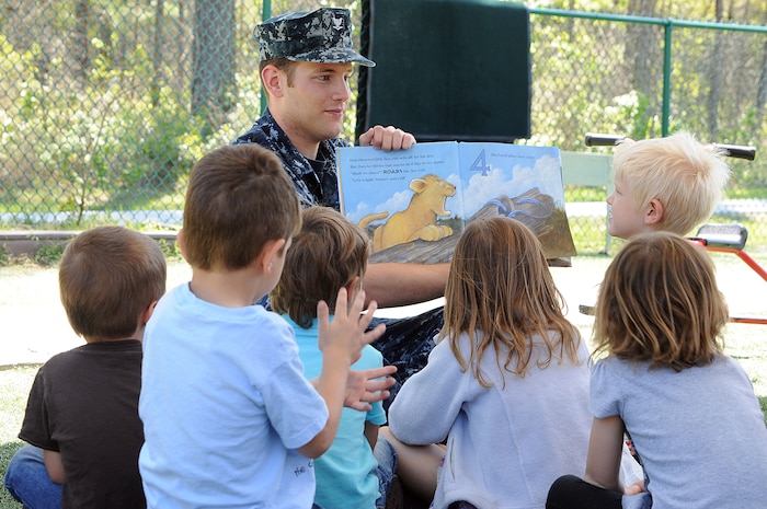 Petty Officer 3rd Class Brandon Bolte answers a question from three-year-old Brody Leonard during story time at the Child Development Center at Joint Base Charleston – Weapons Station April, 11. Bolte, an Electrician’s Mate from Fort Collins, Colo., works at the CDC while he waits on his next set of orders. Brody is the son of Jim and Holly Leonard who both work at Space and Naval Warfare Systems Command Atlantic. (U.S. Navy photo/Petty Officer 1st Class Jennifer Hudson)