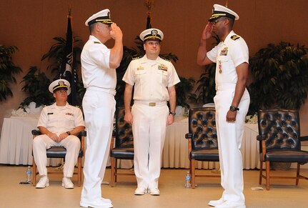 Commander Charles Phillip, left, relieves Cmdr. Marquis Patton as the Navy Munitions Command Unit Charleston commanding officer during a routine change of command ceremony at the RedBank Club at Joint Base Charleston – Air Base April 12. Capt. Charles Marks from the Navy Munitions Command Continental United States East Division, center, presided over the ceremony. Patton is replacing Phillip as the Naval Support Activity executive officer. (U.S. Navy photo/ Petty Officer 1st Class Jennifer Hudson)