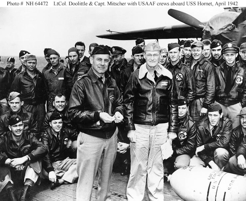 Lt. Col. James Doolittle and Capt. Marc Mitscher pose with United States Army Air Force crewmembers aboard USS Hornet (CV-8), April 1942. (U.S. Navy photo)