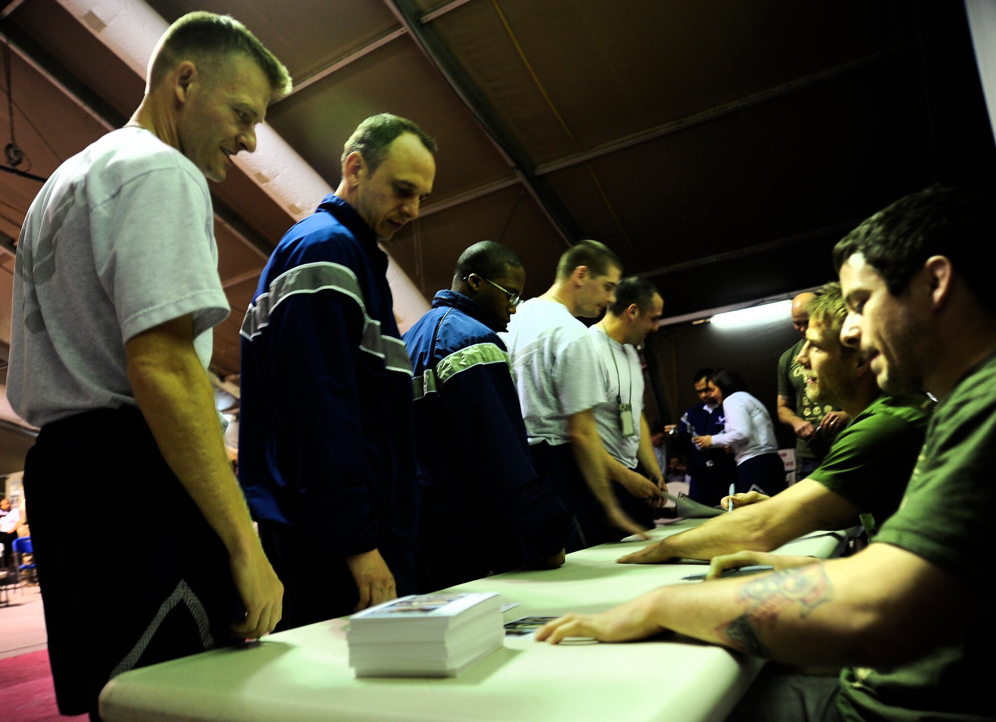 Air Force members wait in line to receive autographs from the Ultimate Fighting Championship fighters in Pete?s Place at the Transit Center at Manas, Kyrgyzstan, April 14, 2012. The UFC fighters, on a tour sponsored by Armed Forces Entertainment spent five days at the Transit Center to boost the morale of deployed service members before heading to Afghanistan. (U.S. Air Force photo/Senior Airman Lynsie Nichols)