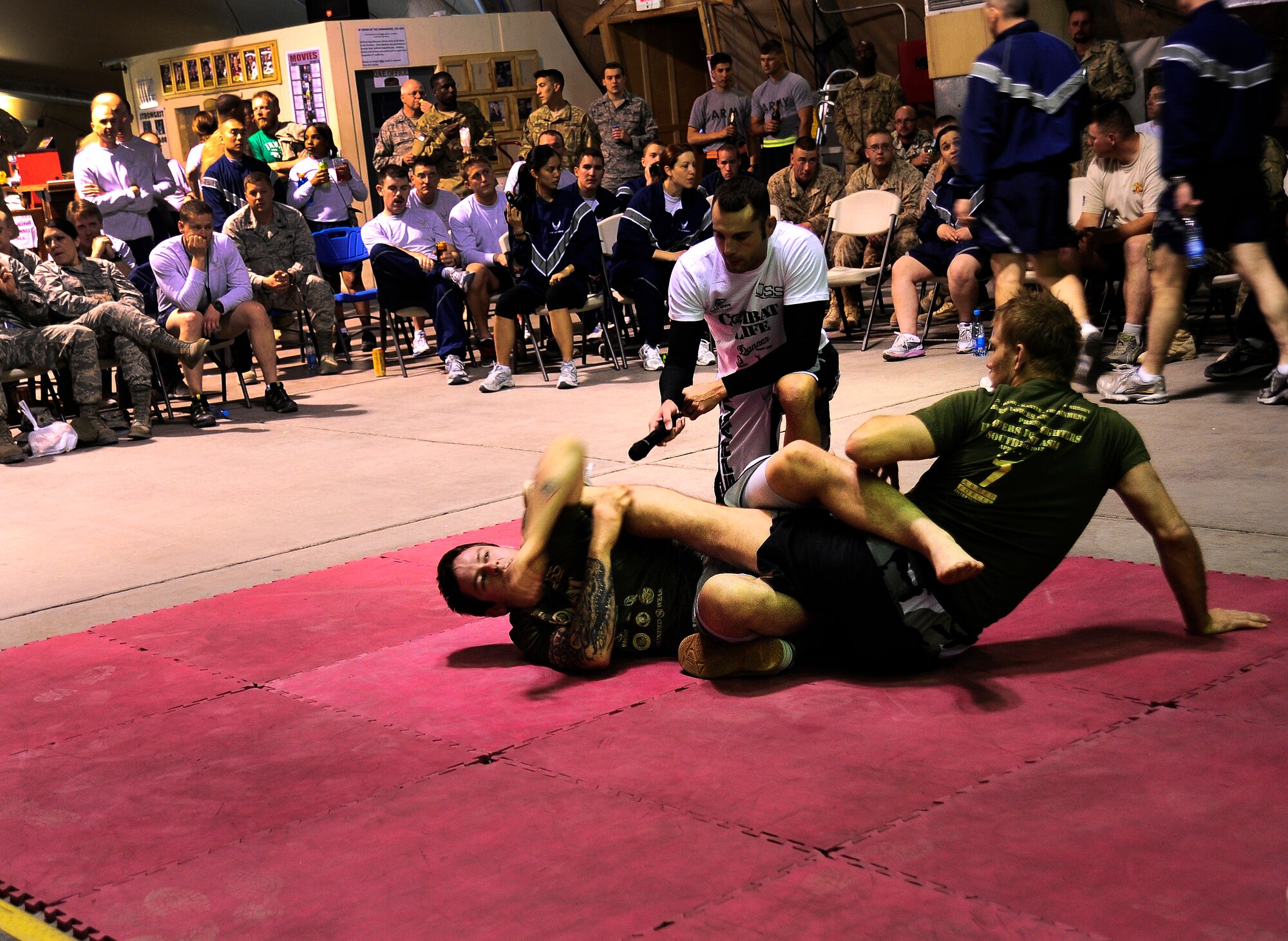 Ben Baxter (l) and Nick Ring (r), both Ultimate Fighting Championship fighters, give a mixed martial arts demonstration in Pete's Place at the Transit Center at Manas, Kyrgyzstan, April 14, 2012. The UFC fighters visited the Transit Center to raise morale and interact with deployed service members. (U.S. Air Force photo/Senior Airman Lynsie Nichols)