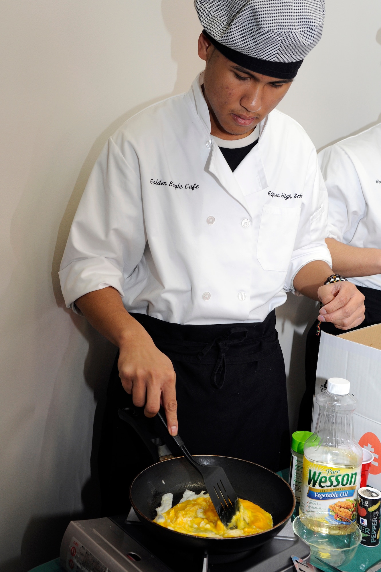 The son of U.S. Air Force Tech. Sgt. Phillip Narcis, 35th Civil Engineer Squadron firefighter, scrambles eggs for the quarterly first sergeants' appreciation breakfast at Misawa Air Base, Japan, April 18, 2012. The 35th Medical Group Mental Health Flight coordinated this quarter's breakfast in connection with The Month of the Military Child and Child Abuse Awareness. (U.S. Air Force photo by Tech. Sgt. Marie Brown/Released)
