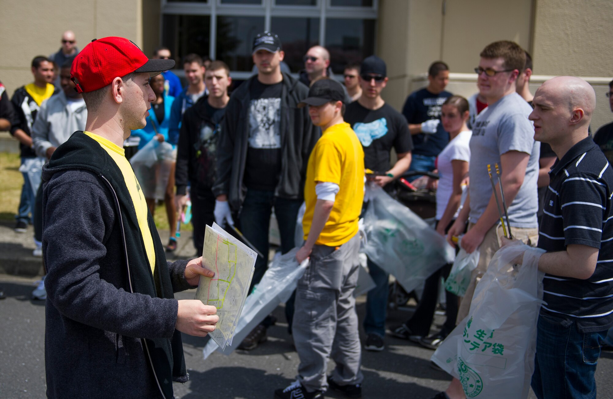YOKOTA AIR BASE, Japan -- Airman 1st Class Gregory Wallace (left), Yokota First Four president, instructs volunteers on their route for picking up trash during the Clean up Fussa Day event April 15, 2012, Yokota Air Base, Japan. More than 60 volunteers signed up to assist in picking up trash. (U.S. Air Force photo/Staff Sgt. Chad C. Strohmeyer)