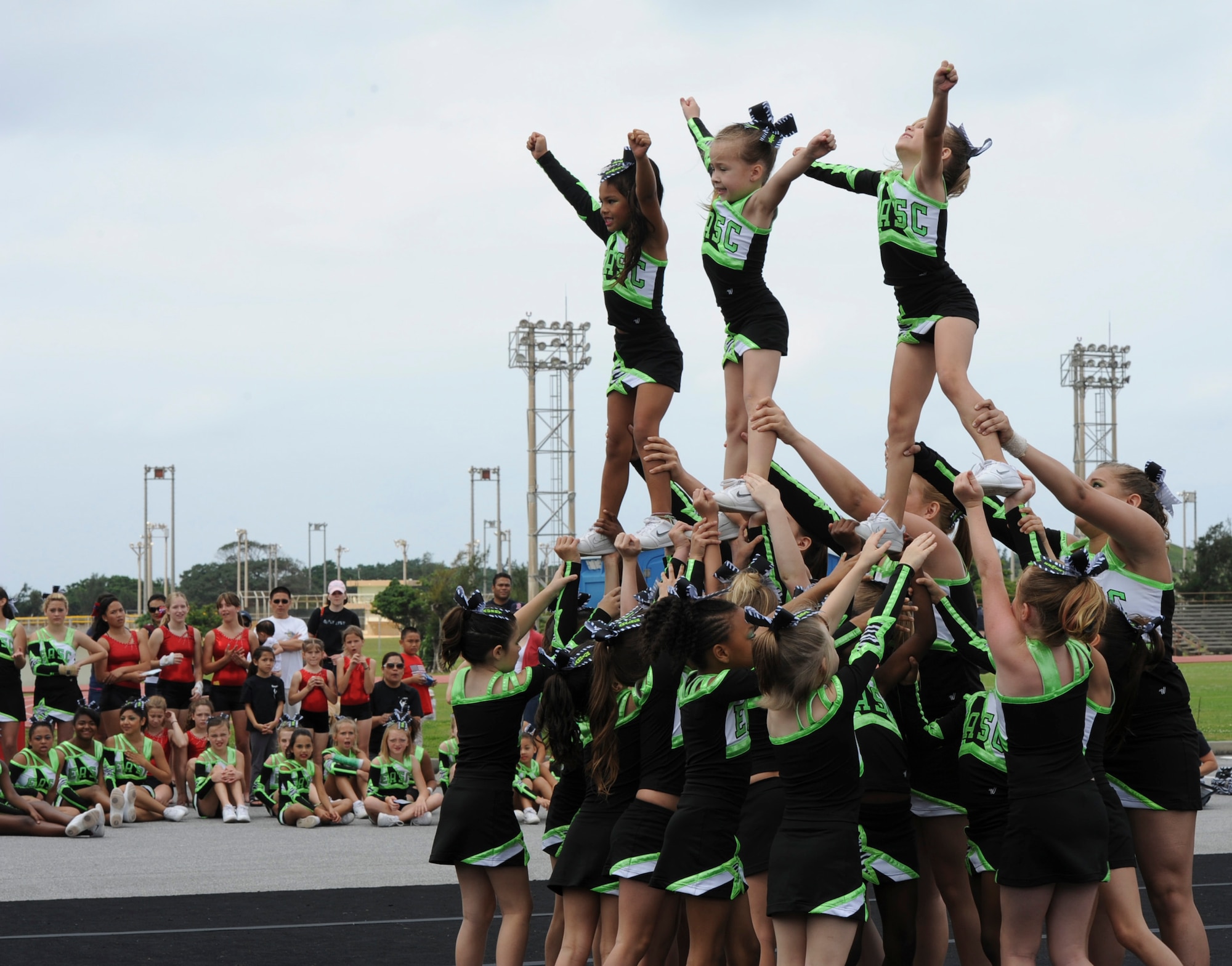 Eagles All-Star cheerleaders execute a pyramid stunt during the second annual EarthFest on Kadena Air Base, Japan, April 14, 2012. The Eagles All-Star cheerleading team is a competitive and performance-based cheer team. (U.S. Air Force photo by Airman 1st Class Justin Veazie/released)