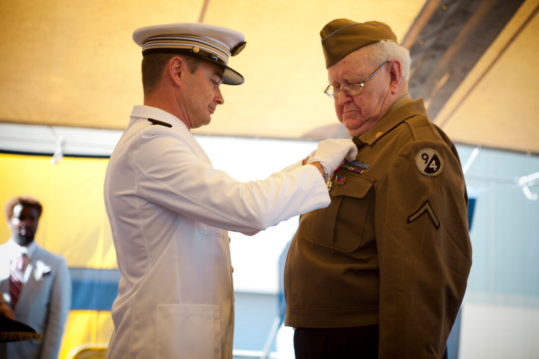 Leon C. Standifer, a World War II veteran, receives the Legion of Honor medal, France’s highest reward for valor, by French Cmdr. Sébastien Chatelain, commander of French frigate Germinal, during a French navy reception aboard Germinal, April 18, 2012. The reception was held in honor of the War of 1812 Commemoration. New Orleans will serve as the inaugural city in a three-year national celebration commemorating the War of 1812 and the Star-Spangled Banner. The Marine Corps' role in this event reinforces its naval character, showcases the Navy-Marine Corps team and highlights the military's enduring relationship with the city of New Orleans. (U.S. Marine Corps photo by Lance Cpl. Marcin Platek/Released)