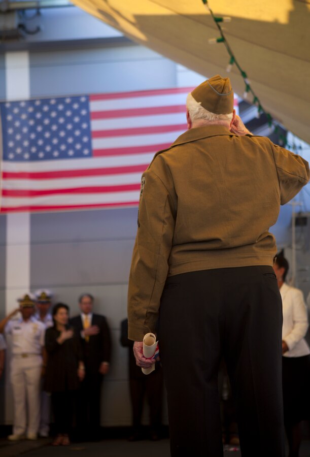 Leon C. Standifer, a World War II veteran, salutes during the national anthem played after he received the Legion of Honor medal, France’s highest reward for valor, during a French navy reception aboard Germinal, April 18, 2012. The reception was held in honor of the War of 1812 Commemoration. New Orleans will serve as the inaugural city in a three-year national celebration commemorating the War of 1812 and the Star-Spangled Banner. The Marine Corps' role in this event reinforces its naval character, showcases the Navy-Marine Corps team and highlights the military's enduring relationship with the city of New Orleans. (U.S. Marine Corps photo by Lance Cpl. Marcin Platek/Released)