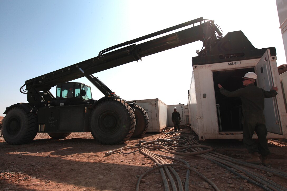 Cpl. Thomas Dragonetti, a mobile maintenance facility technician with Marine Aviation Logistics Squadron 16 and Discovery Bay, Calif., native, observes the movement of a mobile maintenance facility aboard Camp Bastion, Afghanistan, April 19, 2012. MALS-16 will send almost 150,000 pounds of maintenance equipment back to the United States as part of the Marine Corps' downsizing efforts in Afghanistan.