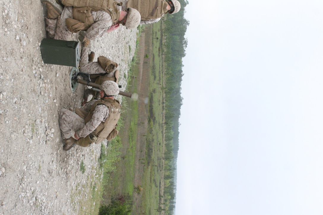 Marines with 2nd Battalion, 2nd Marine Regiment, 2nd Marine Division, duck down as they fire the M224A1 mortar system during a division mortar exercise.  The Division Training Center organized the exercise to give division mortarmen an opportunity to fire the M224A1, an updated model of the M224 Legacy, so they could have the chance to familiarize themselves with the changes.