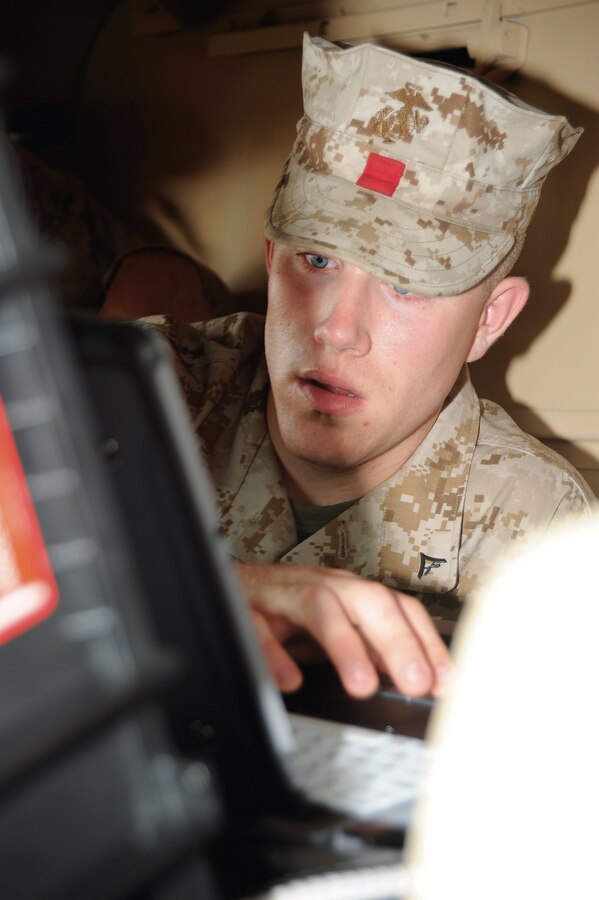 Lance Cpl. Nicholas Nation, landing support specialist, Combat Logistics Regiment 37, Okinawa, Japan, works with a portable deployment kit during training at the Distribution Management Center, April 5. He was among a group of Marines training April 1-9 for a deployment to Kuwait.