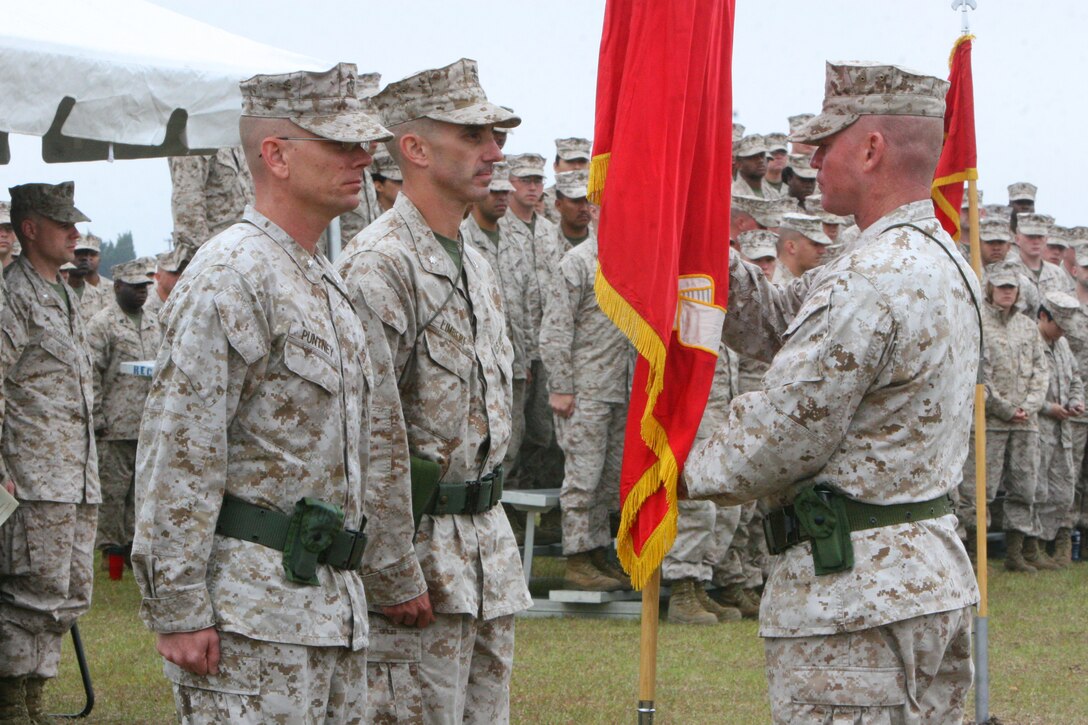 Sgt. Maj. Thomas W. Foster, sergeant major for Marine Wing Communications Squadron 28, 2nd Marine Aircraft Wing, presents the unit colors to outgoing squadron commanding officer, Lt. Col. Gregory T. Puntney, during a change of command ceremony aboard Marine Corps Air Station Cherry Point, N.C., April 19, 2012. Lt. Col. Matthew E. Limbert, incoming squadron commander, said he received a warm welcome during the turnover and looks forward to working with the squadron. "To the Marines, thank you for everything you have done and you will do. I look forward to (working with you) every day," he said.