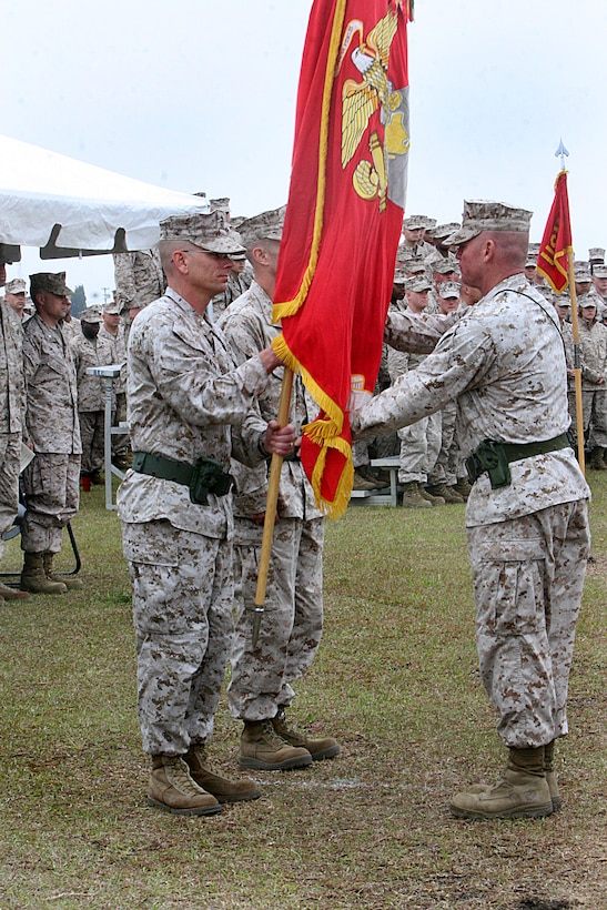Lt. Col. Gregory T. Puntney, outgoing commanding officer of Marine Wing Communications Squadron 28, 2nd Marine Aircraft Wing, takes the unit colors from squadron sergeant major, Sgt. Maj. Thomas W. Foster, during a change of command ceremony aboard Marine Corps Air Station Cherry Point, N.C., April 19, 2012. "I came alongside them 18 months ago and they were focused on preparing for combat," said Puntney. "We kept that objective, kept that priority. We ultimately supported more than 80 units and 10,000 Marines and enabled command and control (in Afghanistan.)"