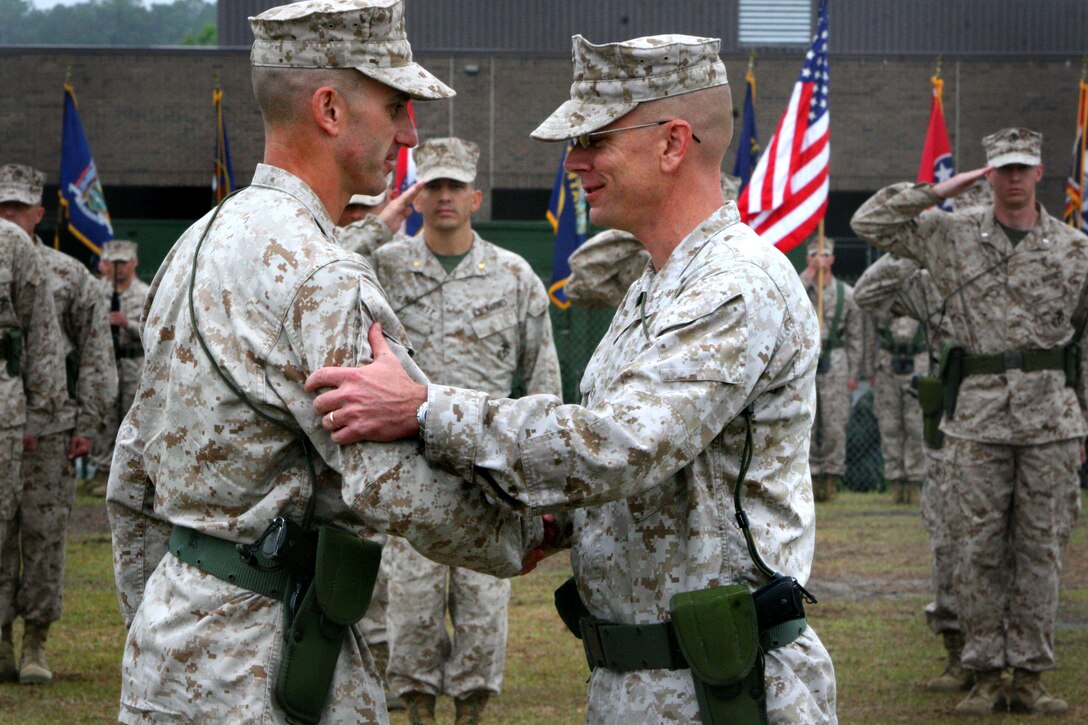Lt. Cols. Gregory T. Puntney, right, and Matthew E. Limbert, incoming and outgoing commanding officers of Marine Wing Communication Squadron 28, 2nd Marine Aircraft Wing, shake hands after transfer of the squadron colors during a change of command ceremony aboard Marine Corps Air Station Cherry Point, N.C., April 19, 2012. "Matt, I look forward to observing from afar how you will lead the Marines and take them to the next level," Puntney said. "They are poised and ready."