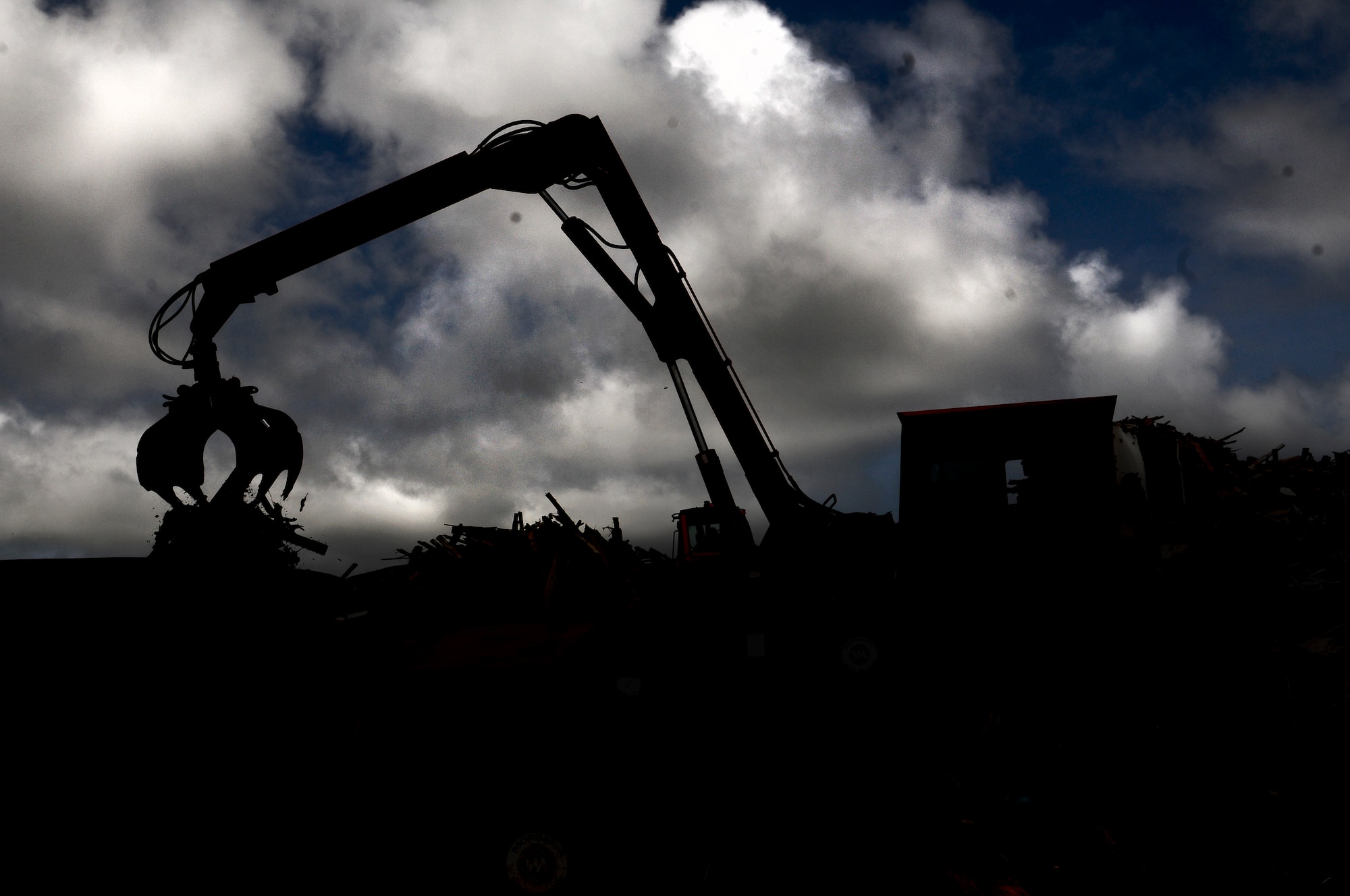 ANDERSEN AIR FORCE BASE, Guam—Airmen from the 36th Civil Engineer Squadron remove debris from the sanitary land fill March 20. The “Dirt Boyz” from the 36 CES conducts several cost efficient projects to enhance the mission capabilities and beautification around base. (U.S. Air Force photo by Airman 1st Class Mariah Haddenham/Released)