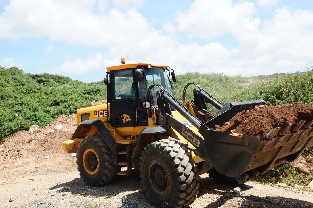 ANDERSEN AIR FORCE BASE, Guam—Airmen from the 36th Civil Engineer Squadron remove debris from the sanitary land fill March 20. The “Dirt Boyz” from the 36 CES conducts several cost efficient projects to enhance the mission capabilities and beautification around base. (U.S. Air Force photo by Airman 1st Class Mariah Haddenham/Released)