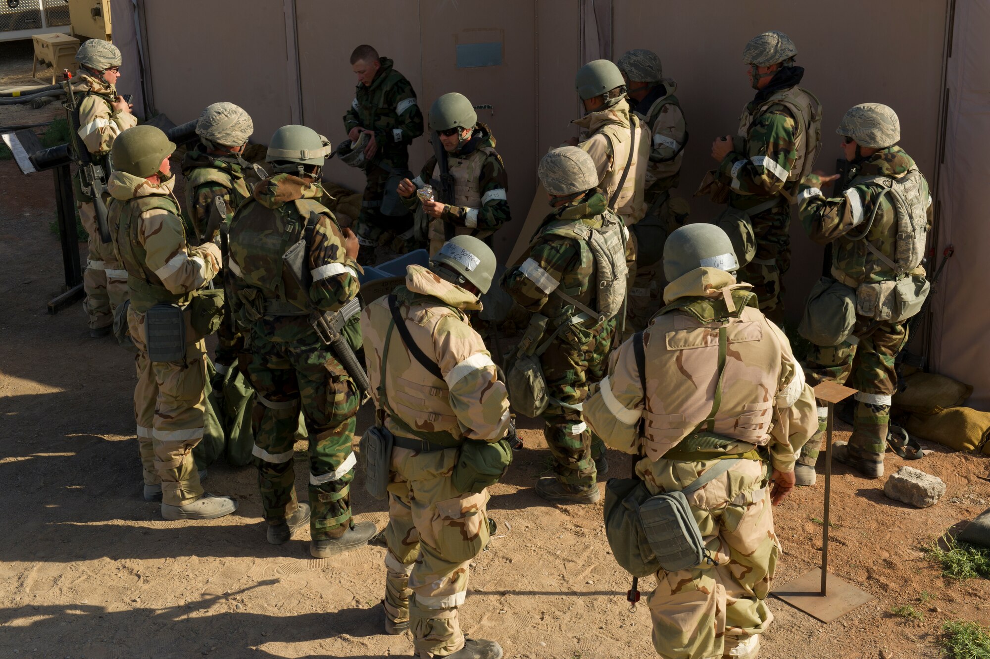 HOLLOMAN AIR FORCE BASE, N.M. – Airmen from the 49th Civil Engineer and Materiel Maintenance Squadrons prepare to wash their boots before entering the unit control center after a simulated chemical attack during a Bivouac exercise April 11. The importance of a sterile environment in a control area is a major priority. The UCC directs military personnel during a base attack and monitors the status of chemical, biological, radiological, nuclear and explosive materials. (U.S. Photo by Airman 1st Class Michael Shoemaker/Released)