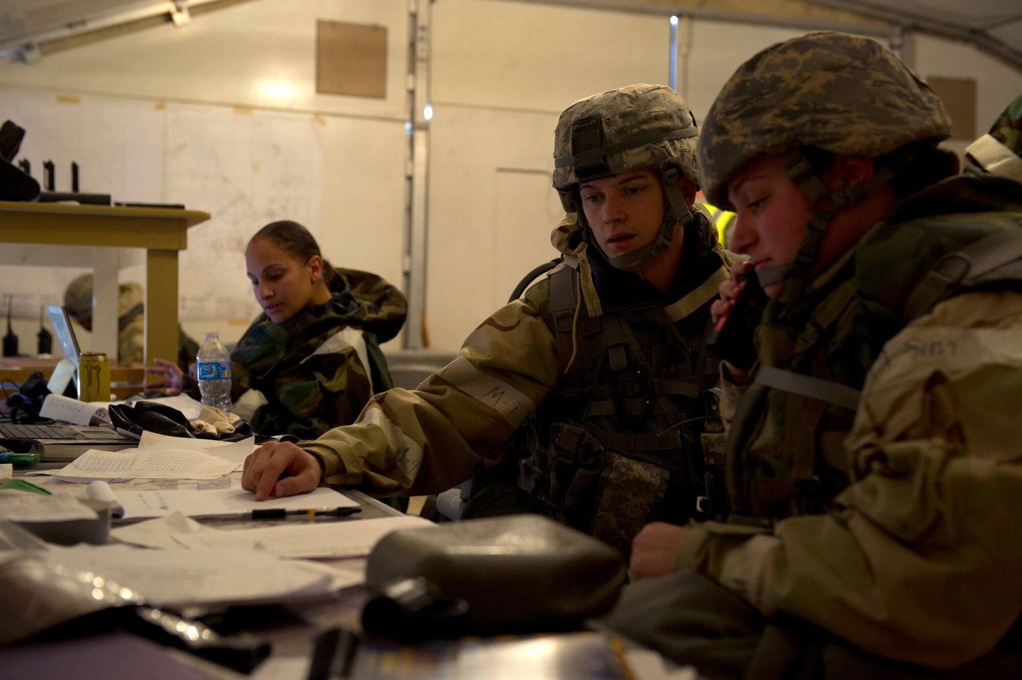 HOLLOMAN AIR FORCE BASE, N.M. – Airmen from the 49th Civil Engineer and Materiel Maintenance Squadrons delegate tasks and gather information for a mock deployment from the unit control center during a Bivouac exercise April 11. The UCC directs military personnel during a base attack and monitors the status of chemical, biological, radiological, nuclear and explosive materials. (U.S. Photo by Airman 1st Class Michael Shoemaker/Released)