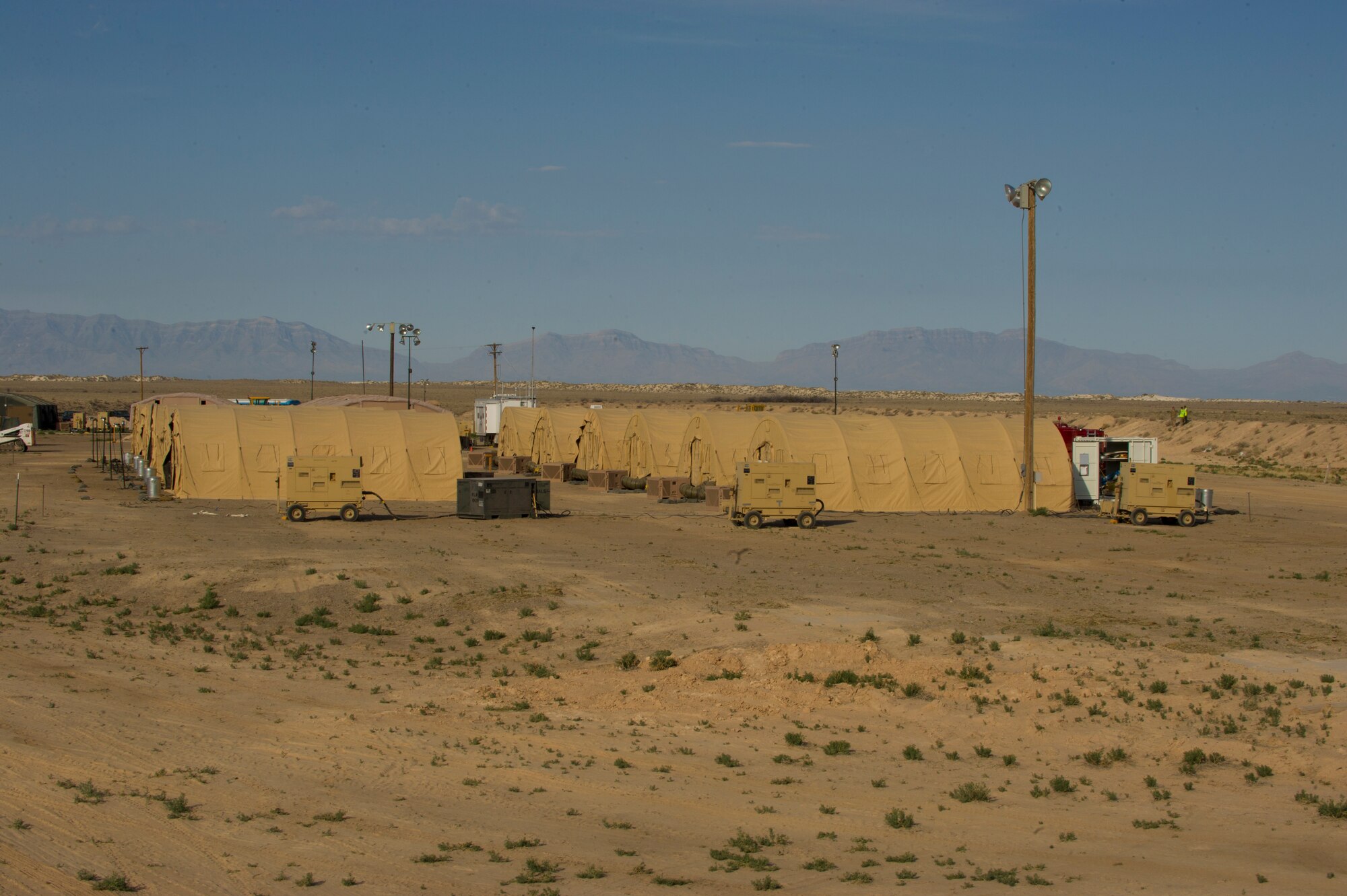 HOLLOMAN AIR FORCE BASE, N.M. – Alaska Small Shelter Systems set up by the 49th Civil Engineer and Materiel Maintenance Squadrons are placed at deployment training site for a Bivouac exercise April 11. These small shelter systems are living quarters for the 130 Airmen who took part in the exercise for the duration of the event. (U.S. Photo by Airman 1st Class Michael Shoemaker/Released)