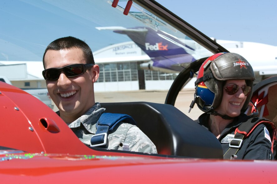 Airman 1st Class Antonio Gonzalez, 2nd Bomb Wing Public Affairs, poses with Jacquie Warda, known as Jacquie B, after landing at the Shreveport Downtown Airport, Shreveport, La., April 19. Gonzalez recorded his flight with Jacquie B to post on social media and document a low-level aerobatics performance in her Pitts Special biplane. Jacquie B will be one of many performers at the 2012 Barksdale Air Force Base Defenders of Liberty Air Show April 21-22. (U.S. Air Force photo/Airman 1st Class Benjamin Gonsier)(RELEASED)
