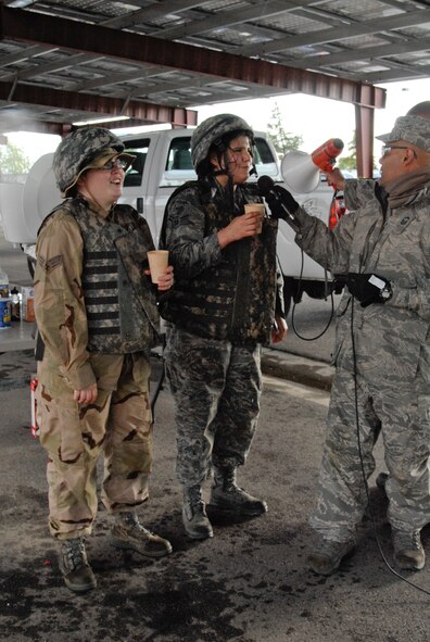 Tech. Sgt. Sarah Gann (left), 144th Force Support Squadron, and Airman 1st Class Shay Swanson (middle), 144th Maintenance Squadron report to Senior Master Sgt. Manuel Hernandez, the Combat Dining In Vice President, for a rule of engagement violation during the 144th Fighter Wing’s Inaugural Combat Dining In held at the Fresno Air National Guard Base on April 14, 2012.   The combat dining in is steeped in tradition and helps build a unit’s esprit de corps.  (Air National Guard photo by Senior Master Sgt. Chris Drudge)