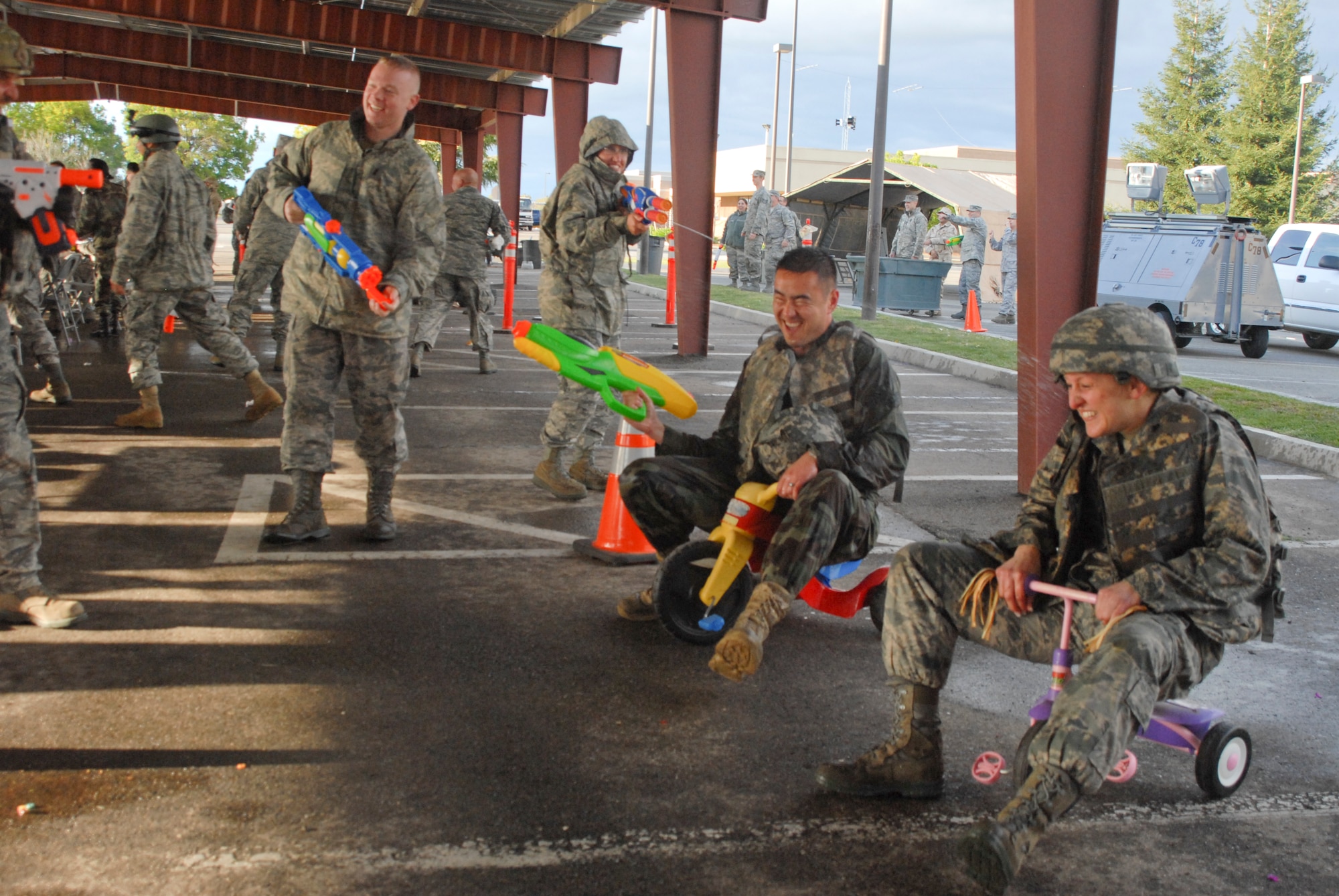 Capt. Michael Yamamoto (middle) and Maj. Malissa Golubic (right), both of the 144th Logistics Readiness Squadron, 144th Fighter Wing, Calif. National Guard, ride tricycles towards the end of the obstacle course during the 144th FW’s Inaugural Combat Dining In held at the Fresno Air National Guard Base on April 14, 2012.   The combat dining in is steeped in tradition and helps build a unit’s esprit de corps.  (Air National Guard photo by Senior Master Sgt. Chris Drudge)