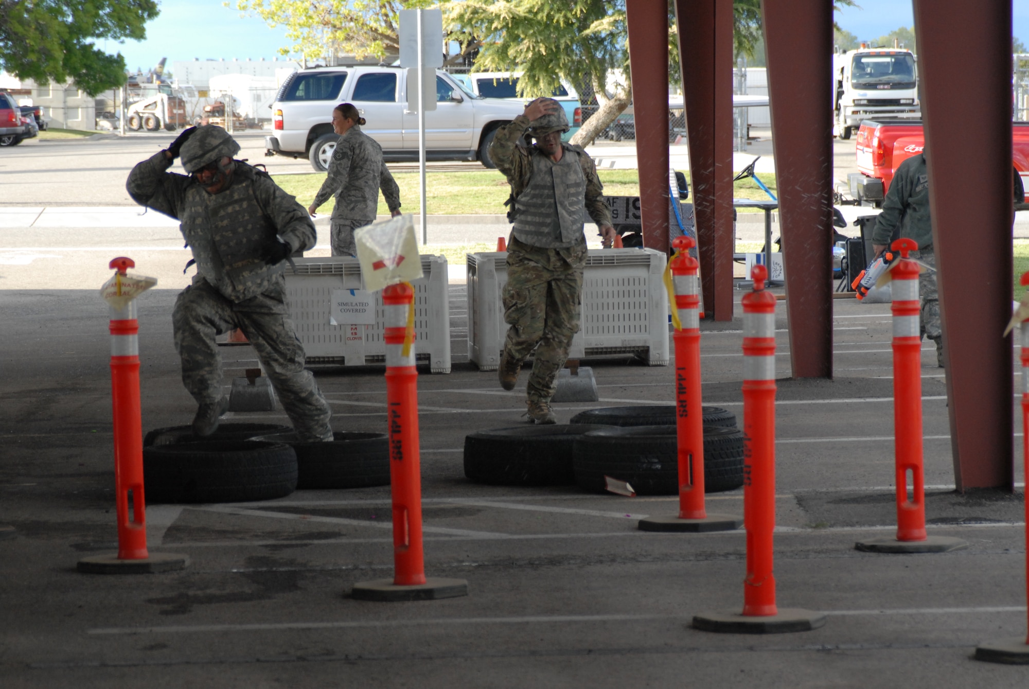 Senior Master Sgt. Manuel Hernandez (left) and 2nd Lt. Nolan Bauer (right), both of the 144th Fighter Wing, Calif. National Guard, run the obstacle course on their way to the “Grog” during the 144th FW’s Inaugural Combat Dining In held at the Fresno Air National Guard Base on April 14, 2012.   The combat dining in is steeped in tradition and helps build a unit’s esprit de corps.  (Air National Guard photo by Senior Master Sgt. Chris Drudge)
