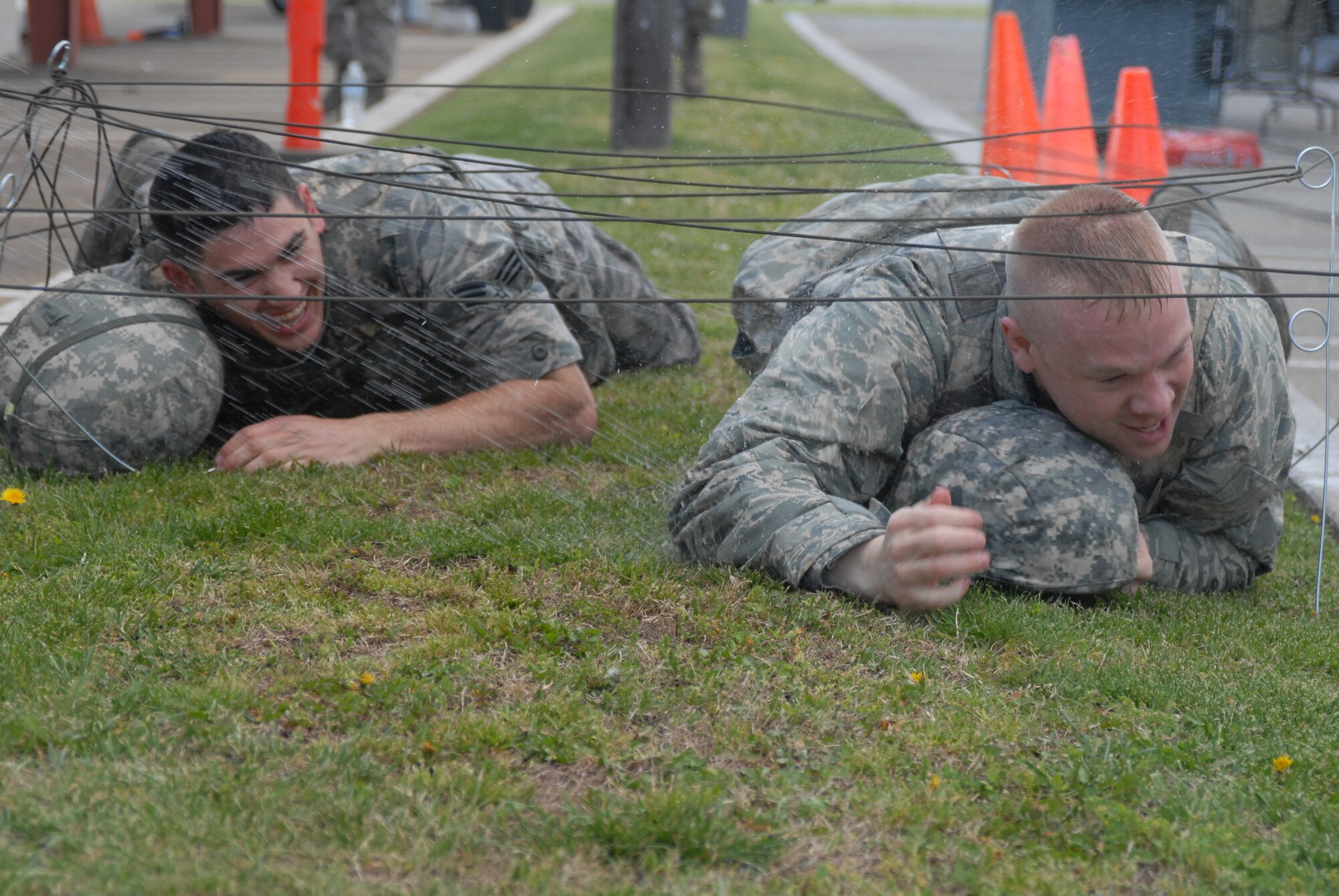 Senior Airman Ryan Calzada (left) and 2nd Lt. Severin Koerner, both of the 144th Logistics Readiness Squadron, 144th Fighter Wing, Calif. National Guard, low crawl through the obstacle course on their way to the “Grog” during the 144th FW’s Inaugural Combat Dining In held at the Fresno Air National Guard Base on April 14, 2012.   The combat dining in is steeped in tradition and helps build a unit’s esprit de corps.  (Air National Guard photo by Senior Master Sgt. Chris Drudge)