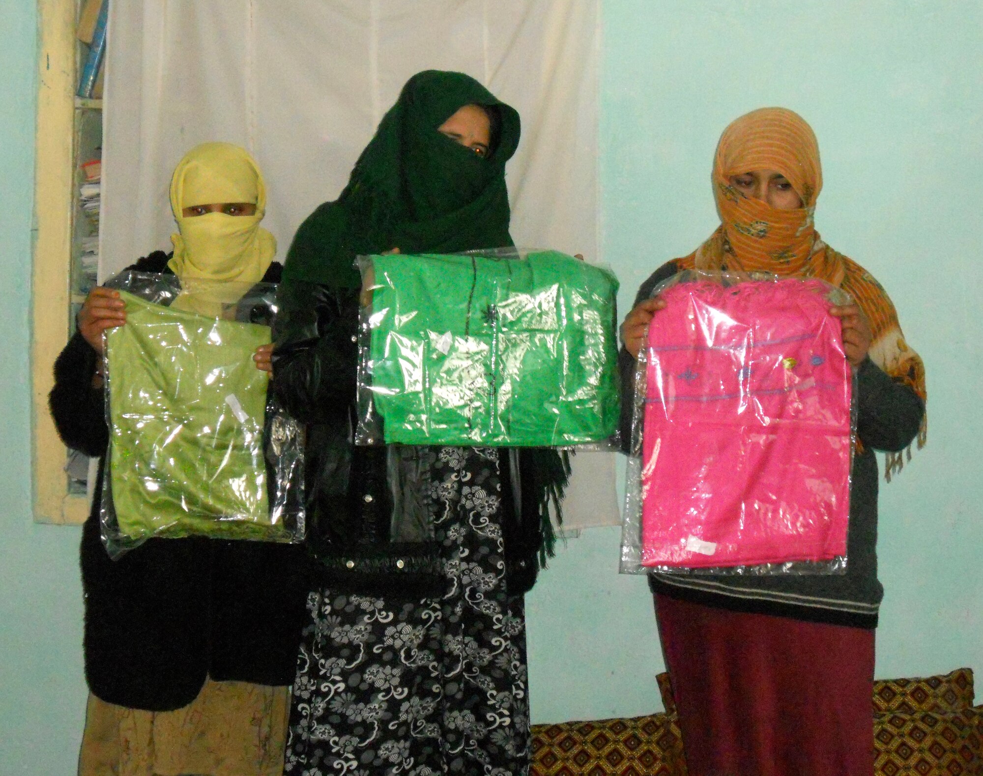 Afghan women display their hand woven scarves in Parwan Province, Afghanistan. Each scarf takes an average of one week to make and are available through the non-profit organization, "Flying Scarfs," which helps impoverished Afghan women and children. (U.S. Air Force courtesy photo/Released)