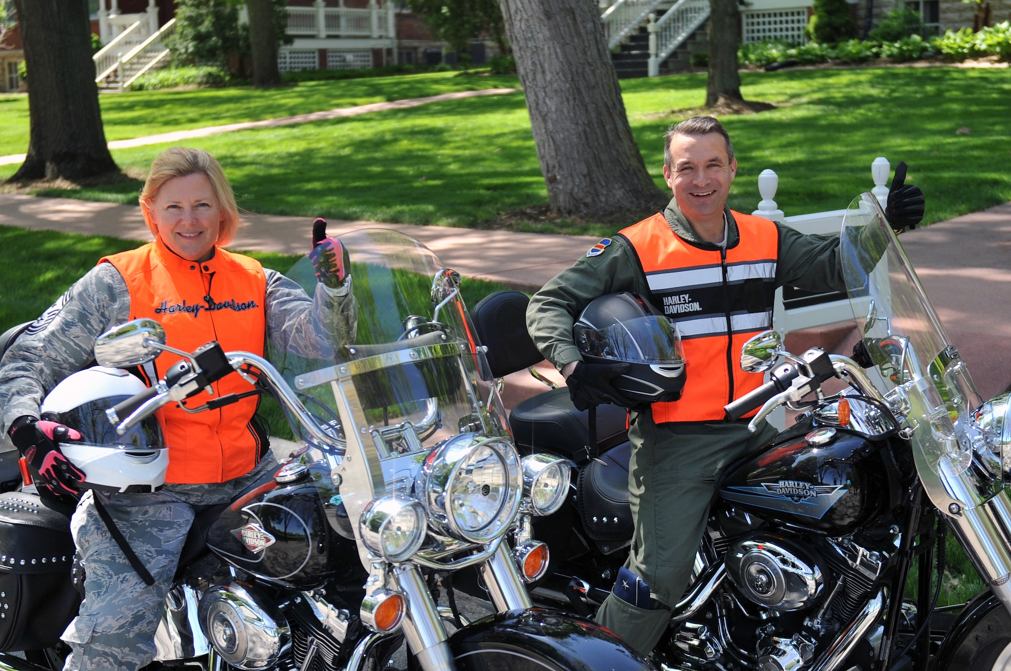 Chief Master Sgt. Suzan Sangster, 55th WG command chief (Left) and  Brig. Gen. Donald Bacon, 55th Wing commander (Right) give two thumbs up on their motorcycles. Both were parked outside generals’ row in support of motorcycle safety at Offutt Air Force Base, Neb., April 11. (U.S. Air Force photo by Jeff Gates/Released)