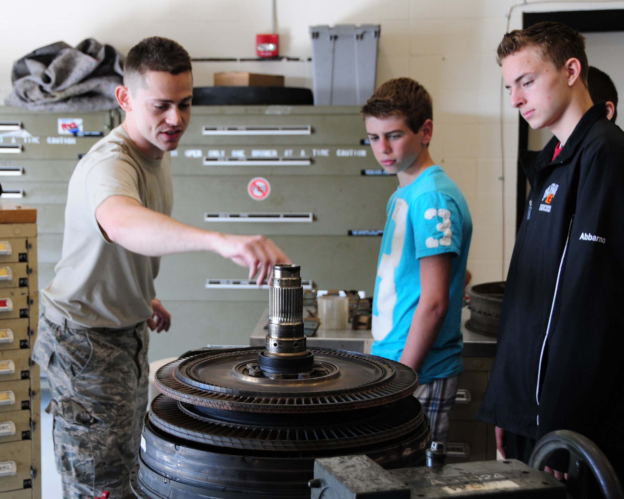 Technical Sgt. Scott Weis, 107th Maintenance Squadron Propulsion Specialist explains the mechanics of a C-130 engine to a group of students in the Propulsion Hangar at Niagara Falls ARS on April 19, 2012. The students from Williamsville East High School were on a tour of the installation. (US Air Force photo by Peter Borys)