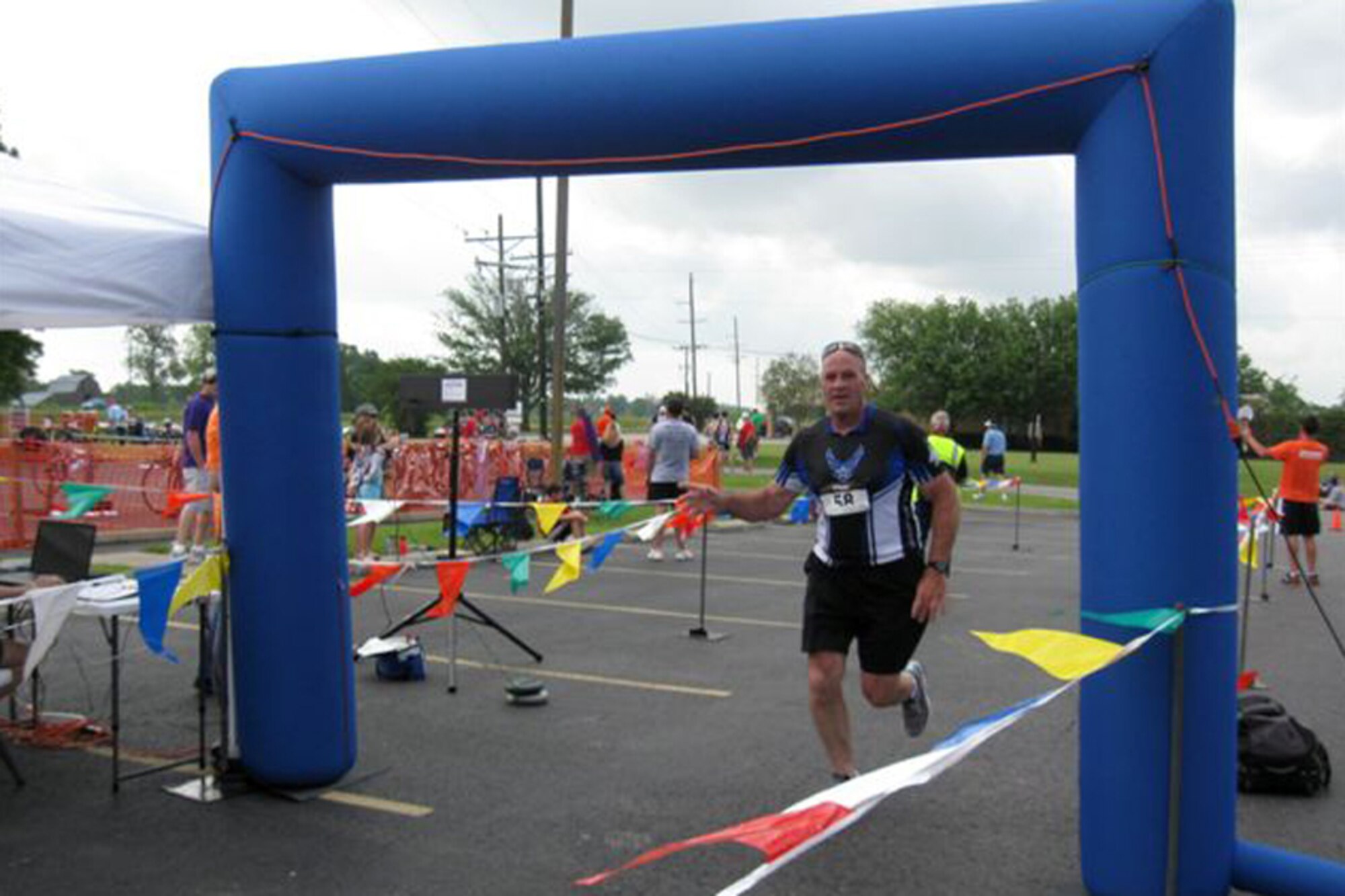 Darryl Moore crosses the finish line of the 16th running of the Opelousas Rotary Sunrise Duathlon in Opelousas, La., April 15, 2012. The duathlon, which Moore completed with a time of 1:39.06, consisted of a 2 mile run/16mile bike/2 mile run. Moore, who is a master sergeant in the Air Force Reserve and the First Sergeant for the 307th Force Support Squadron, runs with his wife Moana, a technical sergeant assigned to the 307th Bomb Wing, to promote military fitness. They are both training to run in the Air Force 1/2 marathon in Ohio in September. (Courtesy photo)