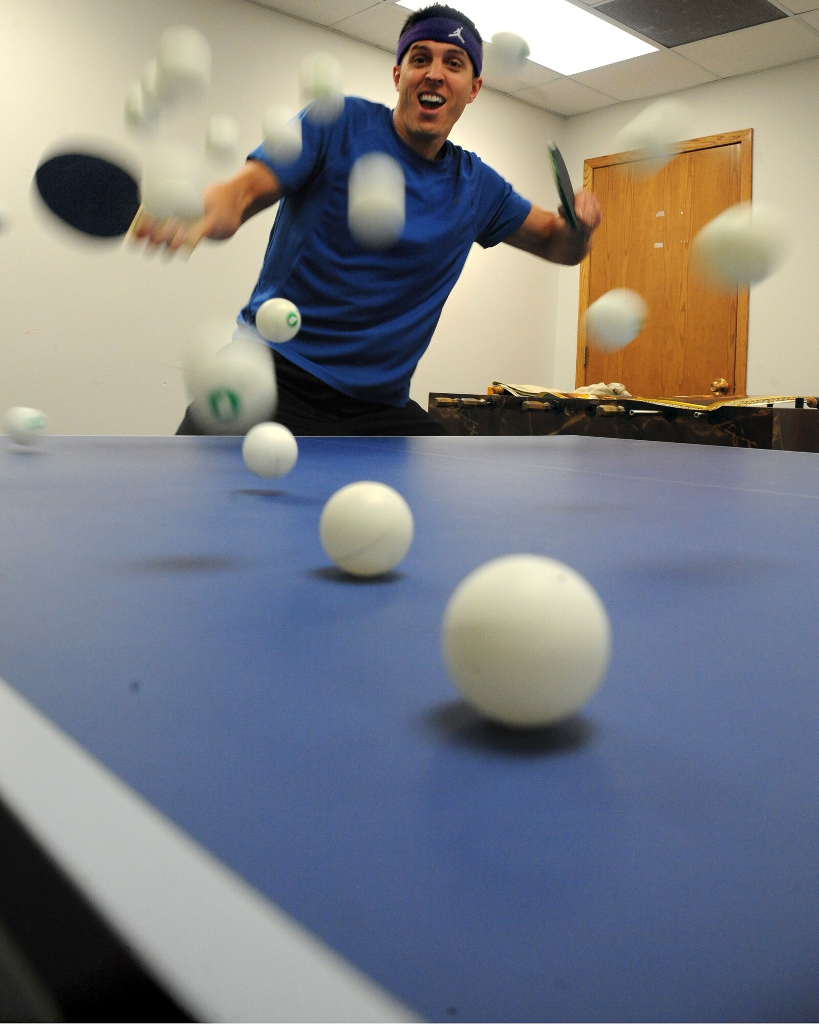 Capt. John Bone, 319th Area Defense Counsel, practices volleying ping pong balls at the Community Activity Center on March 20, 2012, on Grand Forks Air Force Base, N.D.  Bone was named as the base’s male Athlete of the Year award for 2011 by the base fitness center. (U.S. Air Force photo by Airman 1st Class Xavier Navarro)