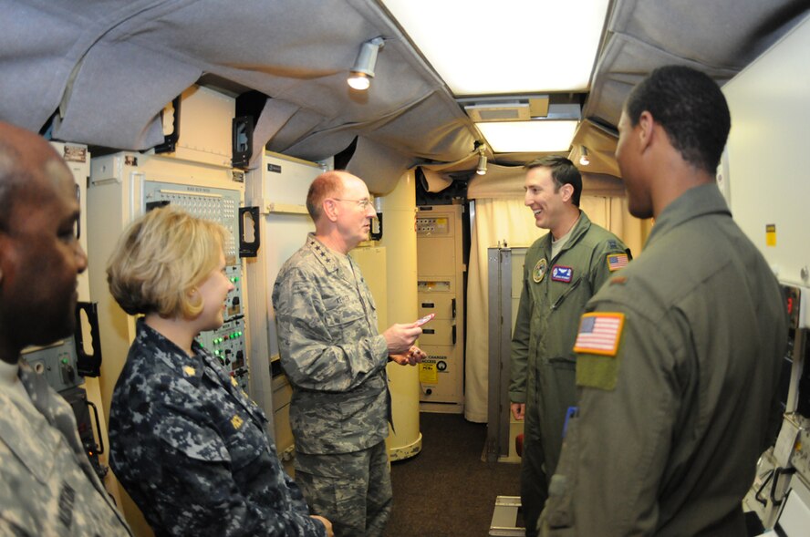 Gen. C. Robert Kehler, commander, United States Strategic Command, accepts a 319th Missile Squadron patch from Capt. Justin Fetherolf, 319th MS Alpha-01 assistant flight commander, and 2nd Lt. Trey Swinton, 319th MS, while Lt. Cmdr. Christina Hicks, USSTRATCOM, and Command Sgt. Maj. Patrick Alston, USSTRATCOM senior enlisted leader, look on in the launch control center of F. E. Warren’s missile alert facility Alpha-01 during Gen. Kehler’s visit April 10. (U.S. Air Force photo by Airman 1st Class Dan Gage)