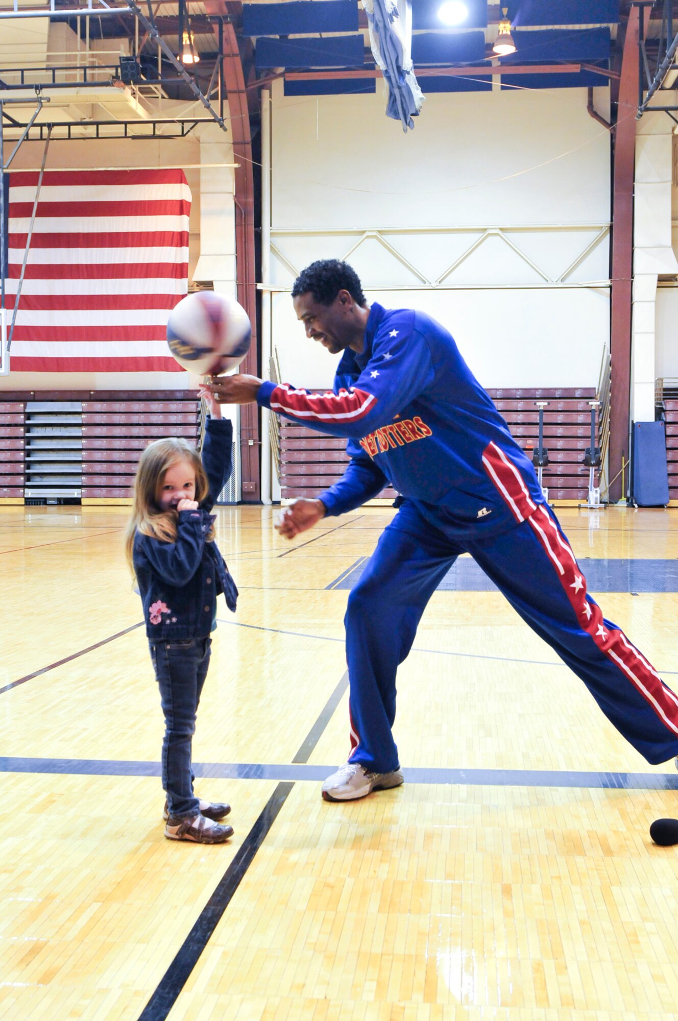 JOINT BASE ELMENDORF-RICHARDSON,Alaska-Wun Versher,"The Shot", Harlem Globe Trotters team member, assisted by Lexi Page, daughter of Army Sgt Vincent Page. The demonstration was at the Buckner Fitness Center on Joint Base Elmendorf-Richardson on 17 April 2012. It was followed by a autograph and photo session. (USAF Photo by Steven White/JBER/PA)