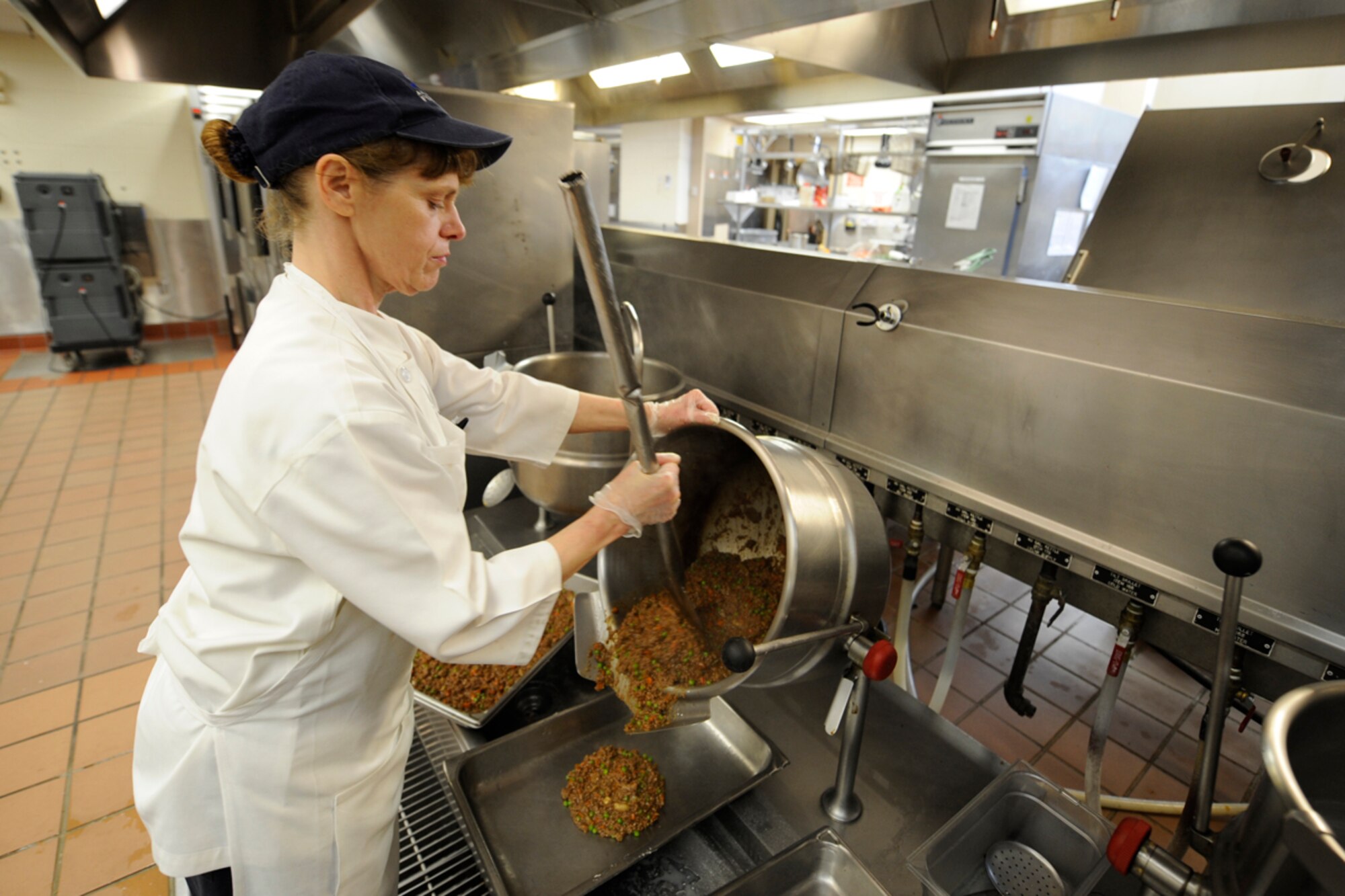 JOINT BASE ELMENDORF-RICHARDSON,Alaska--Phyllis Chaussee, 673 ABW/ FSS, Joint Base Elmendorf-Richardson,starts preparing shepherds pie dish for the dinner meal at the Iditarod Dining Facility on base, 17 April 2012. (USAF Photo by Steven White/JBER/PA)