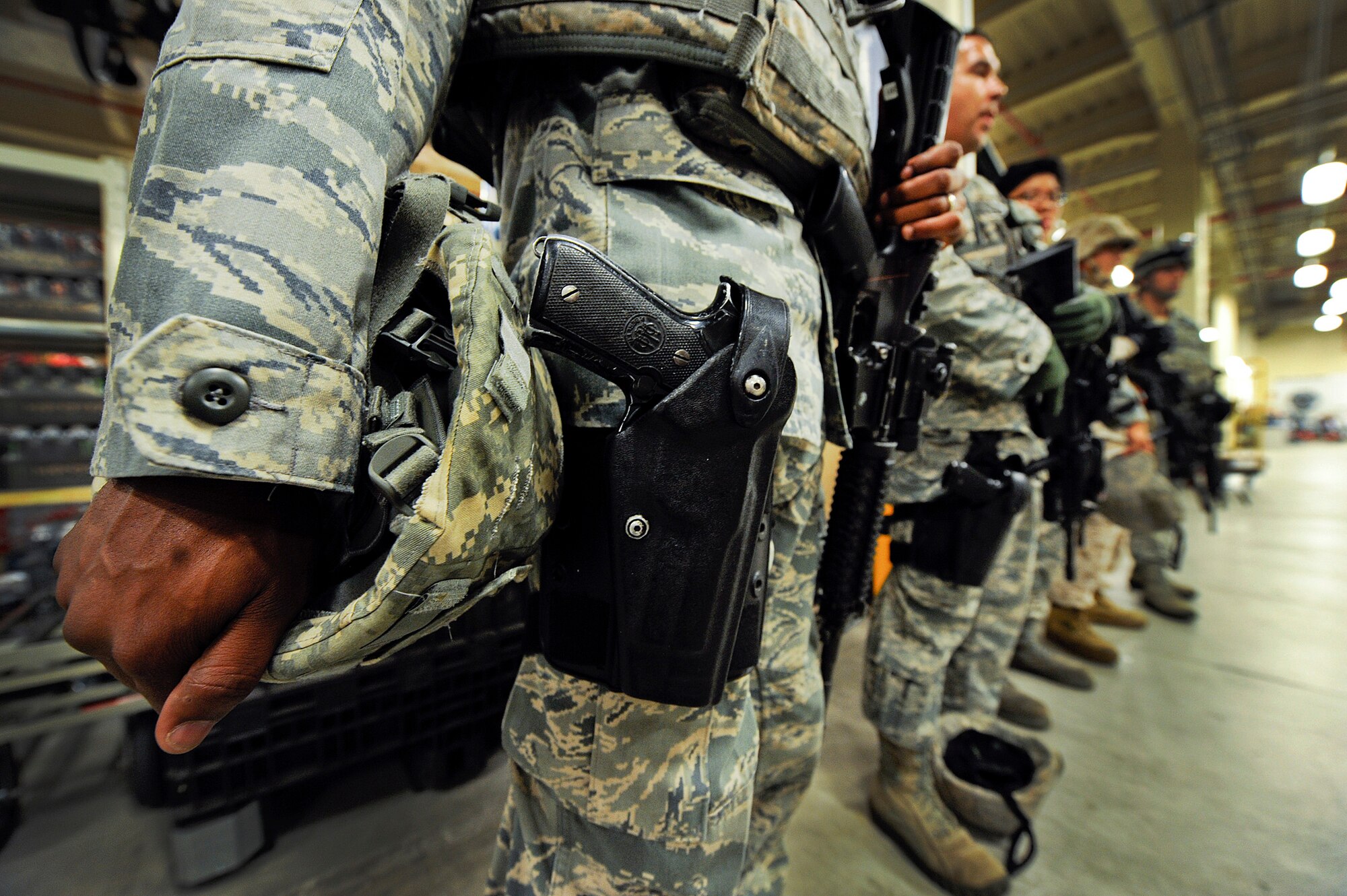Service members participating in the Pacific Air Forces High-Risk Response Training active shooter scenario receive a debriefing from an instructor following the scenario at Kadena Air Base, Japan, April 13, 2012. The scenario used volunteers from around the base in a familiar setting to give realism to the participants. (U.S. Air Force photo/Airman 1st Class Maeson L. Elleman)
