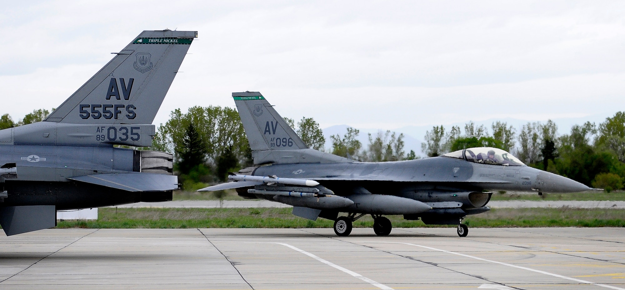 GRAF IGNATIEVO AIR FORCE BASE, Bulgaria -- Two 555th Fighter Squadron F-16 pilots prepare their jets for de-arming after landing here April 17, 2012 from Aviano Air Base, Italy. More than two dozen aircraft and 500 U.S. Airmen from the 31st Fighter Wing at Aviano AB are taking part in Thracian Star 2012, a month-long joint training exercise focused on building partnerships and increasing interoperability with the Bulgarian air force. This is the third time since 2007 that men and women from the 31st FW have conducted this type of training with the Bulgarians. (U.S. Air Force photo/Senior Airman Katherine Windish)